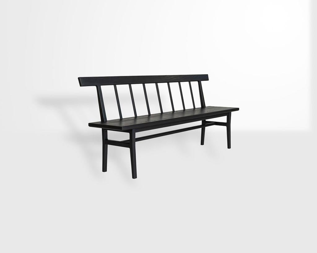 A clean modernization of a Classic Windsor bench, this settee features sculpted legs and slats instead of dowels and spindles. Constructed from sustainable blackened ash, the settee is artisan crafted with traditional joinery and finished with an