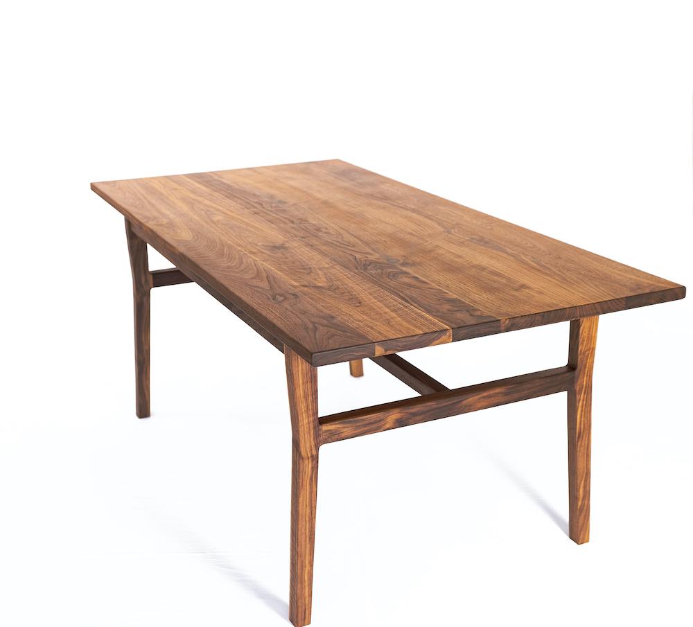 Inspired by Danish simplicity and organic design, the laurel table features sculpted legs, modest angles, and sturdy joinery. The table is constructed from sustainable walnut with each leg joint hand-filed and shaped to flow seamlessly into the
