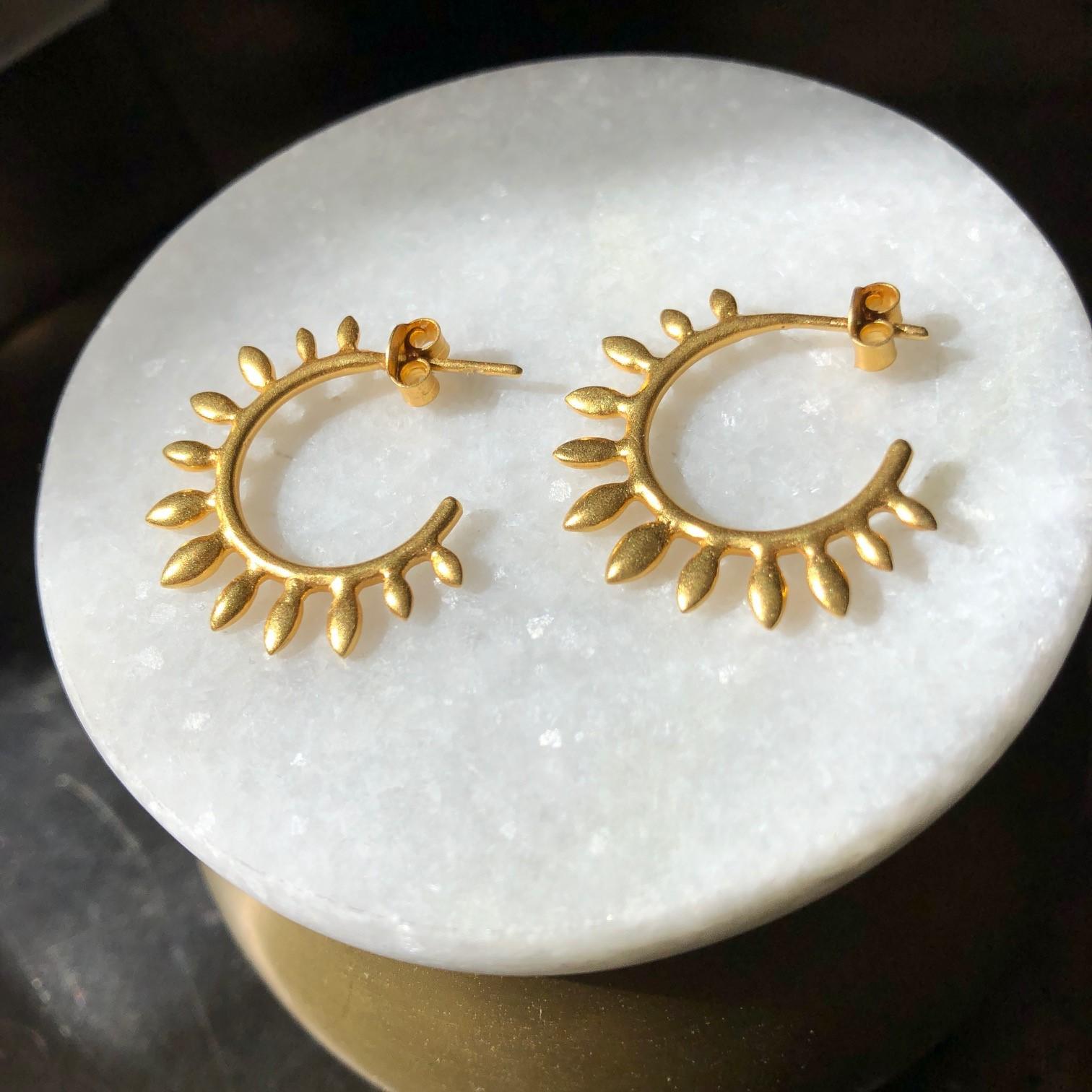 Organic and contemporary, these spiked leaf hoops are solid 18kt Gold, in a soft matte finish.  Incredibly light weight, these earrings will be the earrings you reach for every day.  Outside size is about the size of a quarter.  Ships directly from