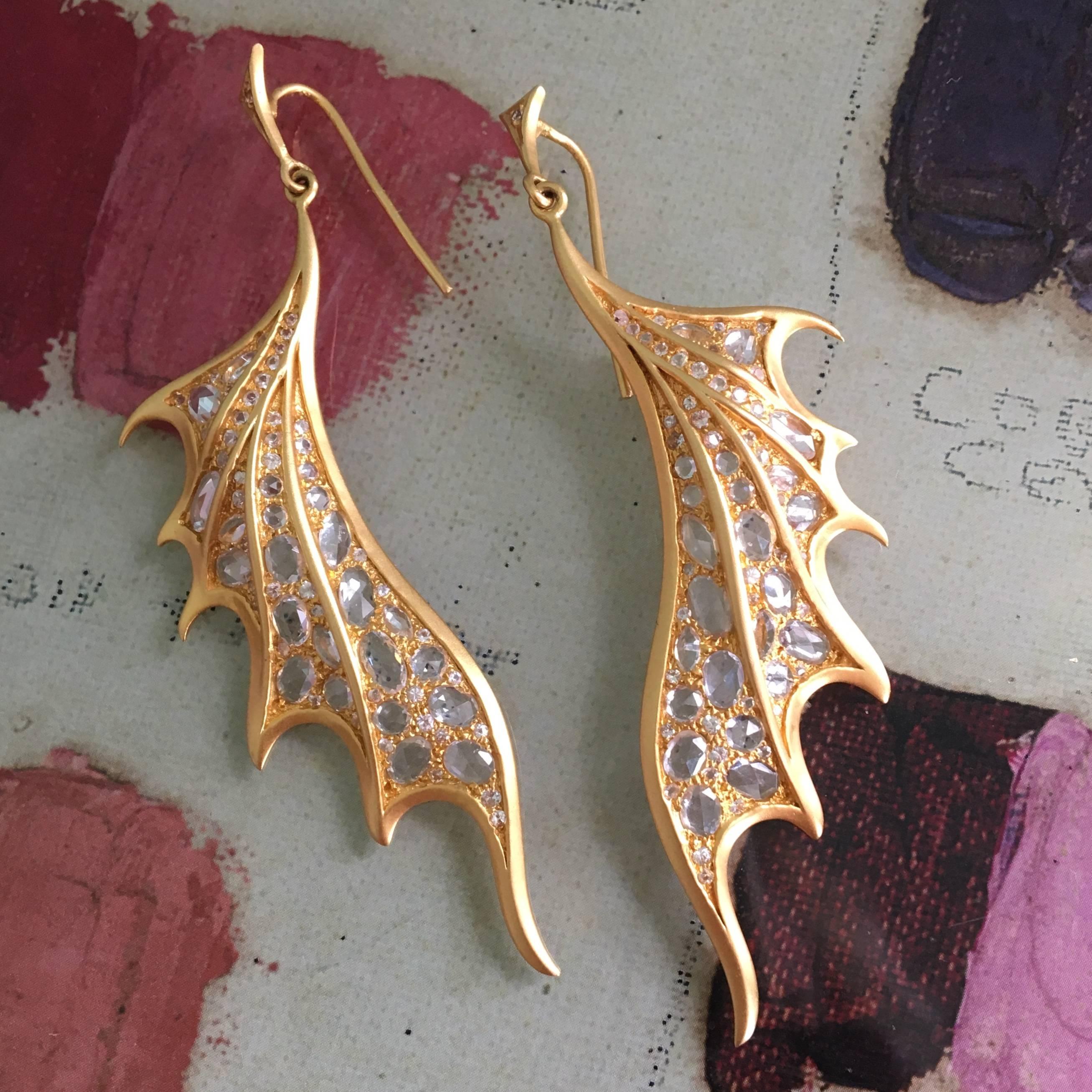 Truly a wow pair of earrings, these rose cut sapphires and 18kt yellow gold earrings make a spectacular  statement.  Designed to resemble dragon wings, these earrings curve gently towards the jawline, making them dramatic and flattering on the face.