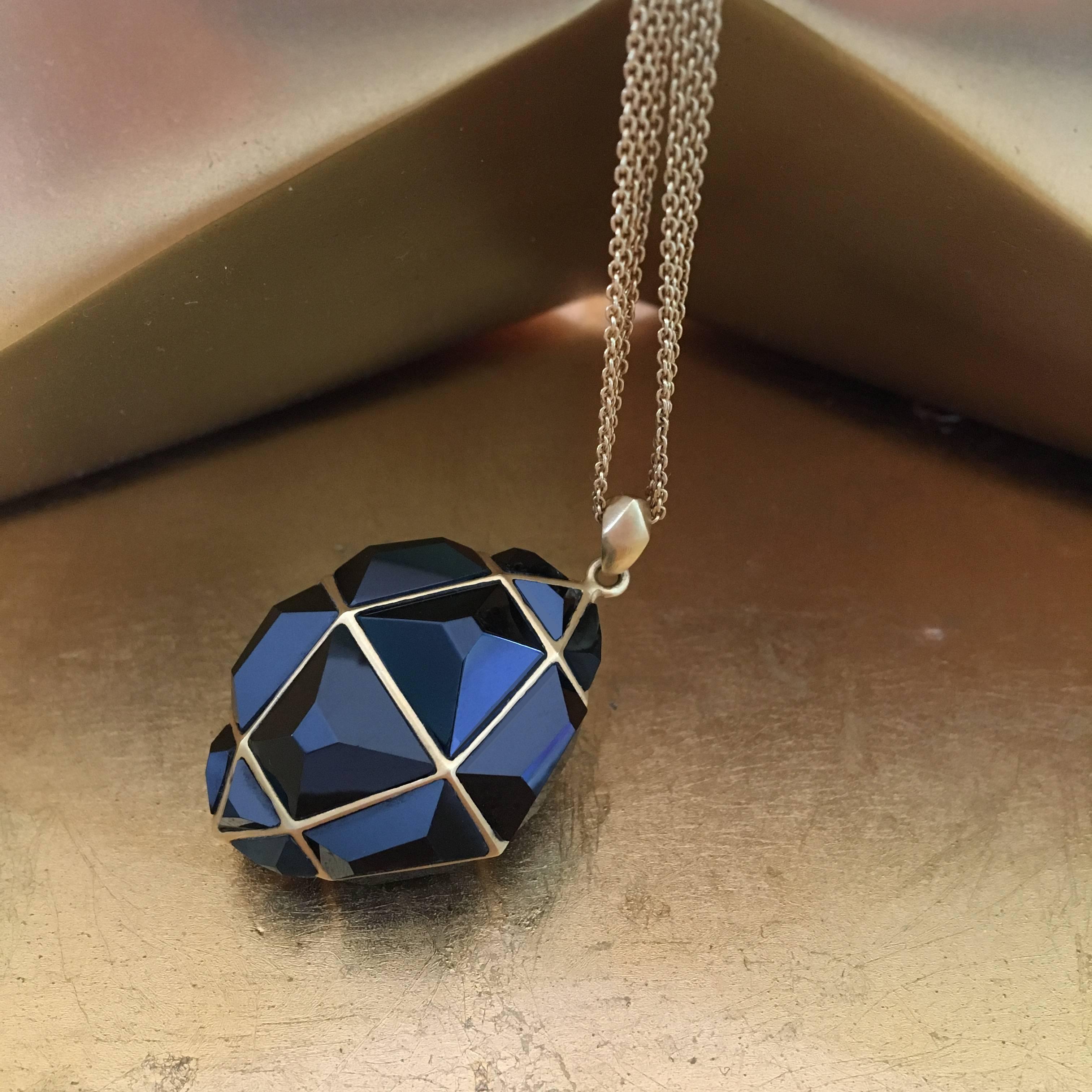 Fierce and strong, this Black Spinel and 18kt Gold necklace will certainly get you noticed.  A geometric puzzle of separately cut black spinel pieces set into one single pendant, this piece is striking and reflective.  Set in Lauren Harper's