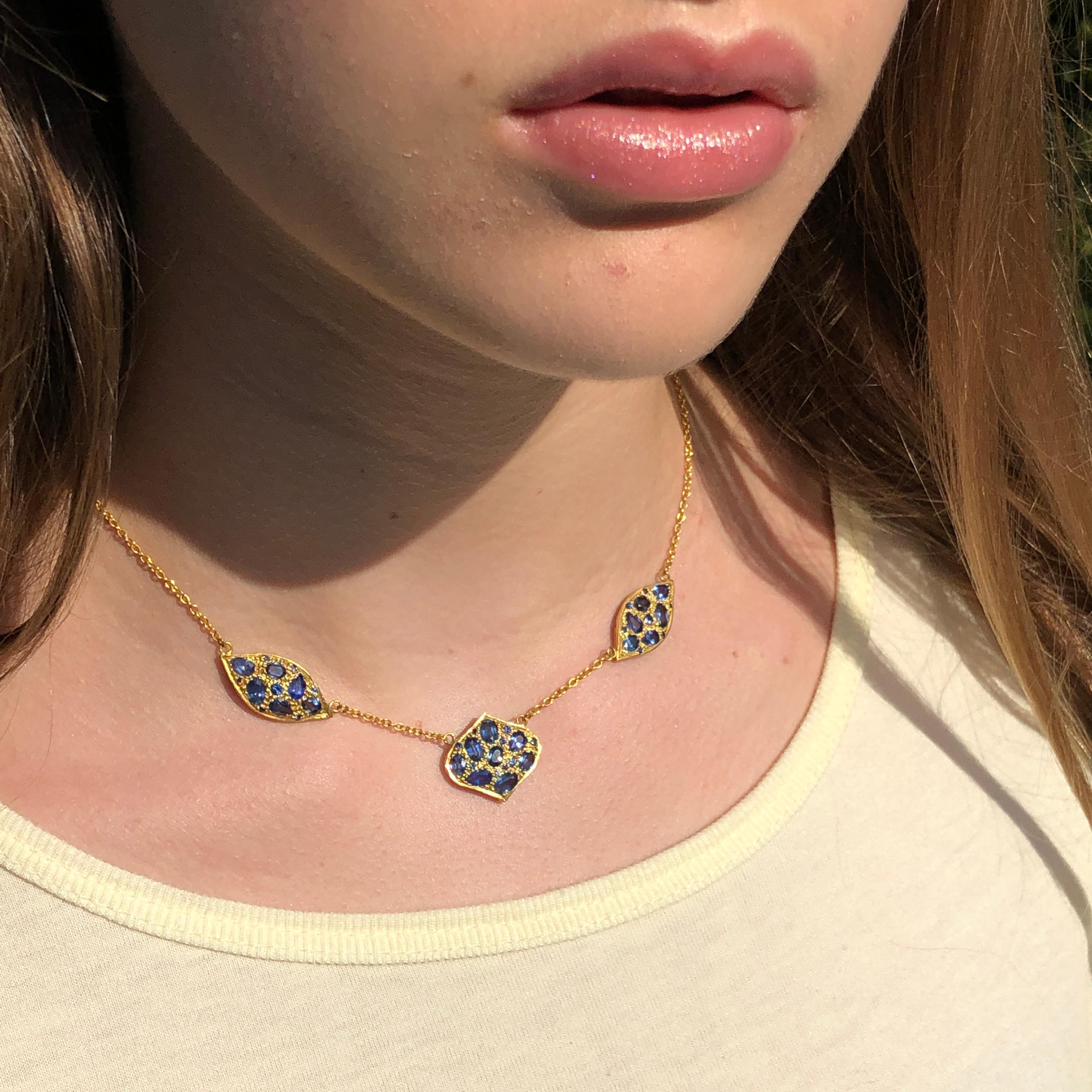 Lauren Harper Collection necklace with Blue Sapphires, delicately set in an 18kt Yellow Gold grain setting on an 18kt Gold chain.  Total length 16.25 inches, but can be adjusted shorter by .75 inches.  Necklace sits right at the nape of the neck,