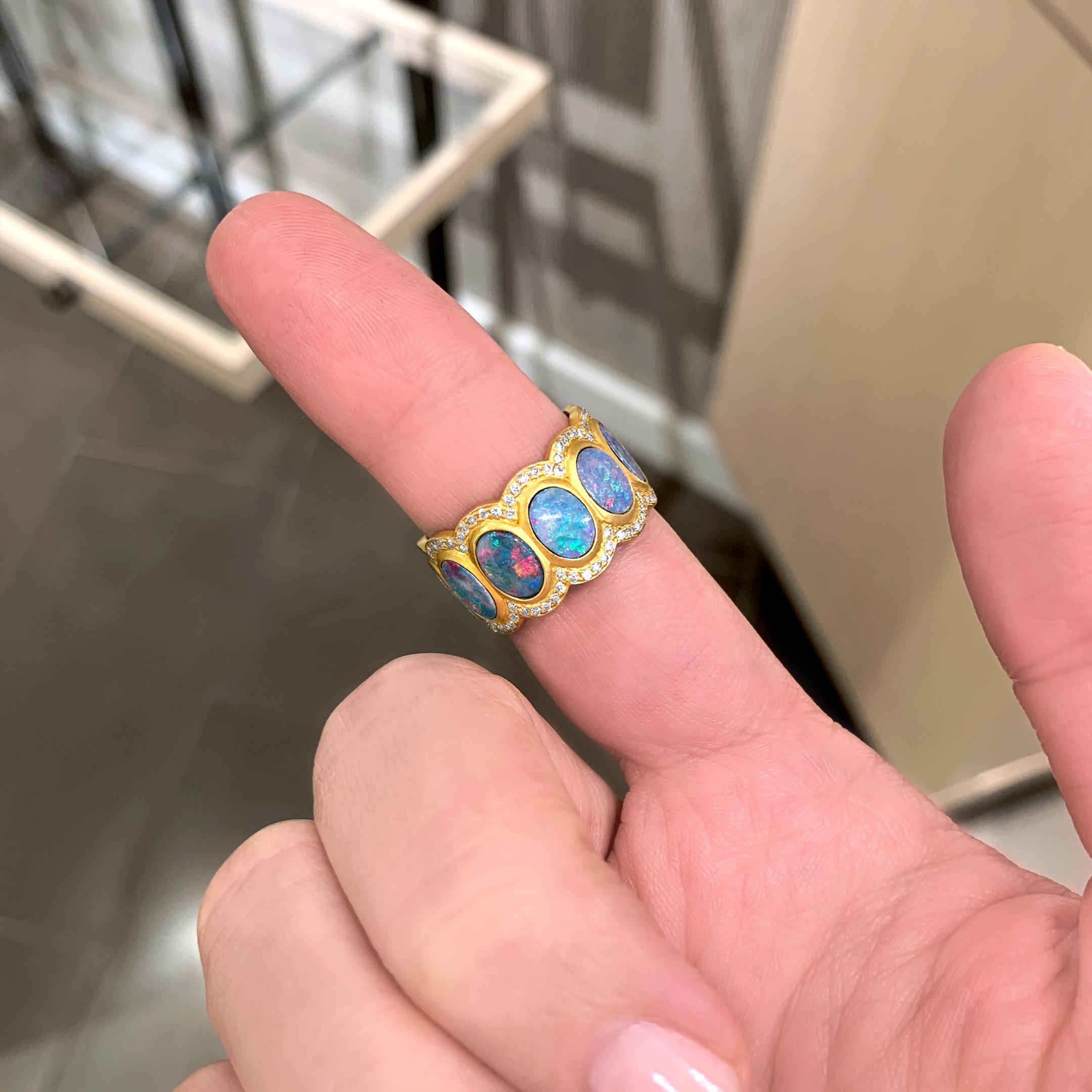 Opal and Diamond Eternity Band handcrafted in matte-finished 18k yellow gold with eleven spectacular, fiery oval boulder opal discs surrounded by two rows of round brilliant-cut white diamonds. Size 7.5 (Can be ordered in alternative size).