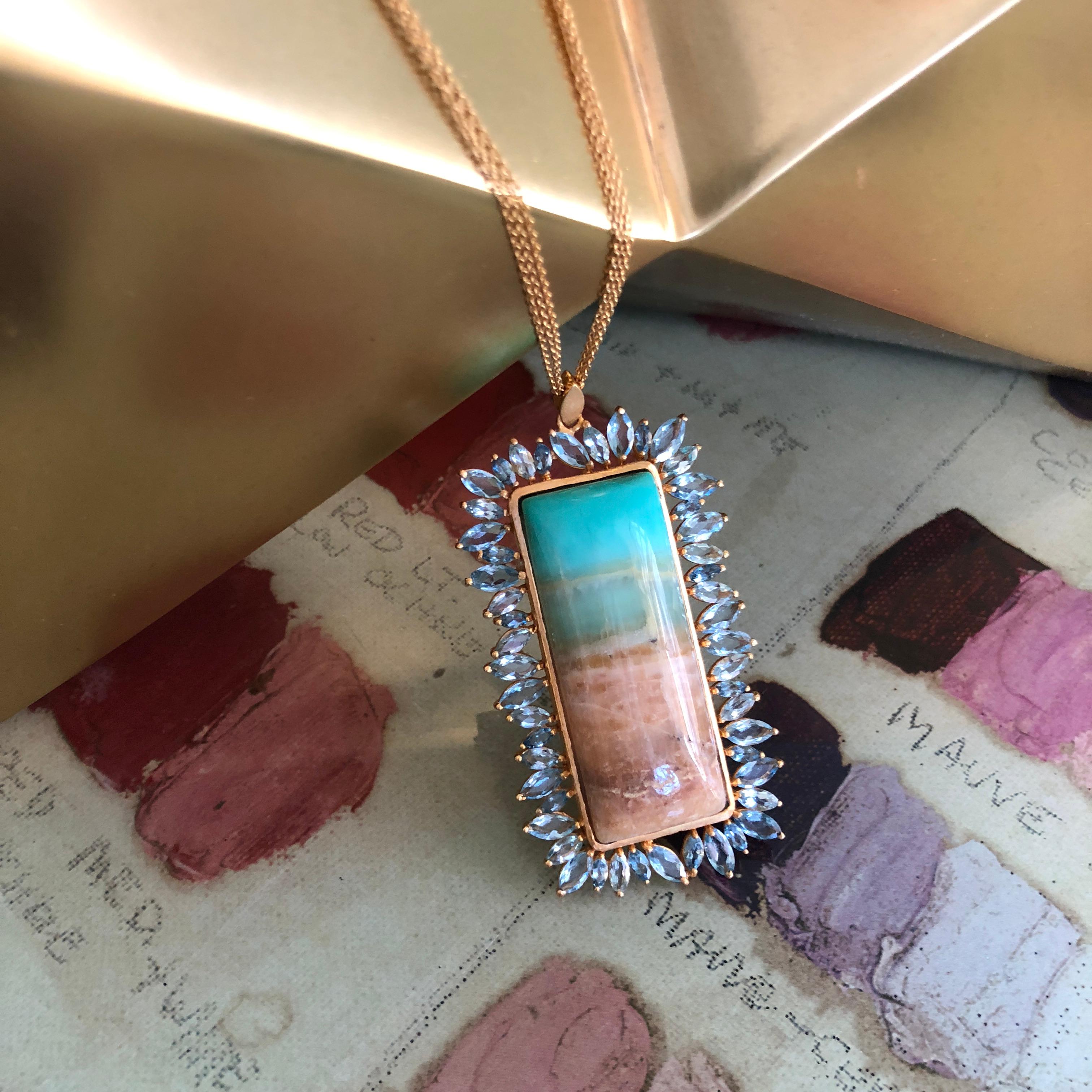 This one of a kind pendant is truly spectacular.  Faceted marquis shaped Aquamarines surround a one of a kind Fossilized Opalized Wood cabachon that has a landscape-like feel to its pattern.  The pendant hangs on a 28 inch chain that is made of 3