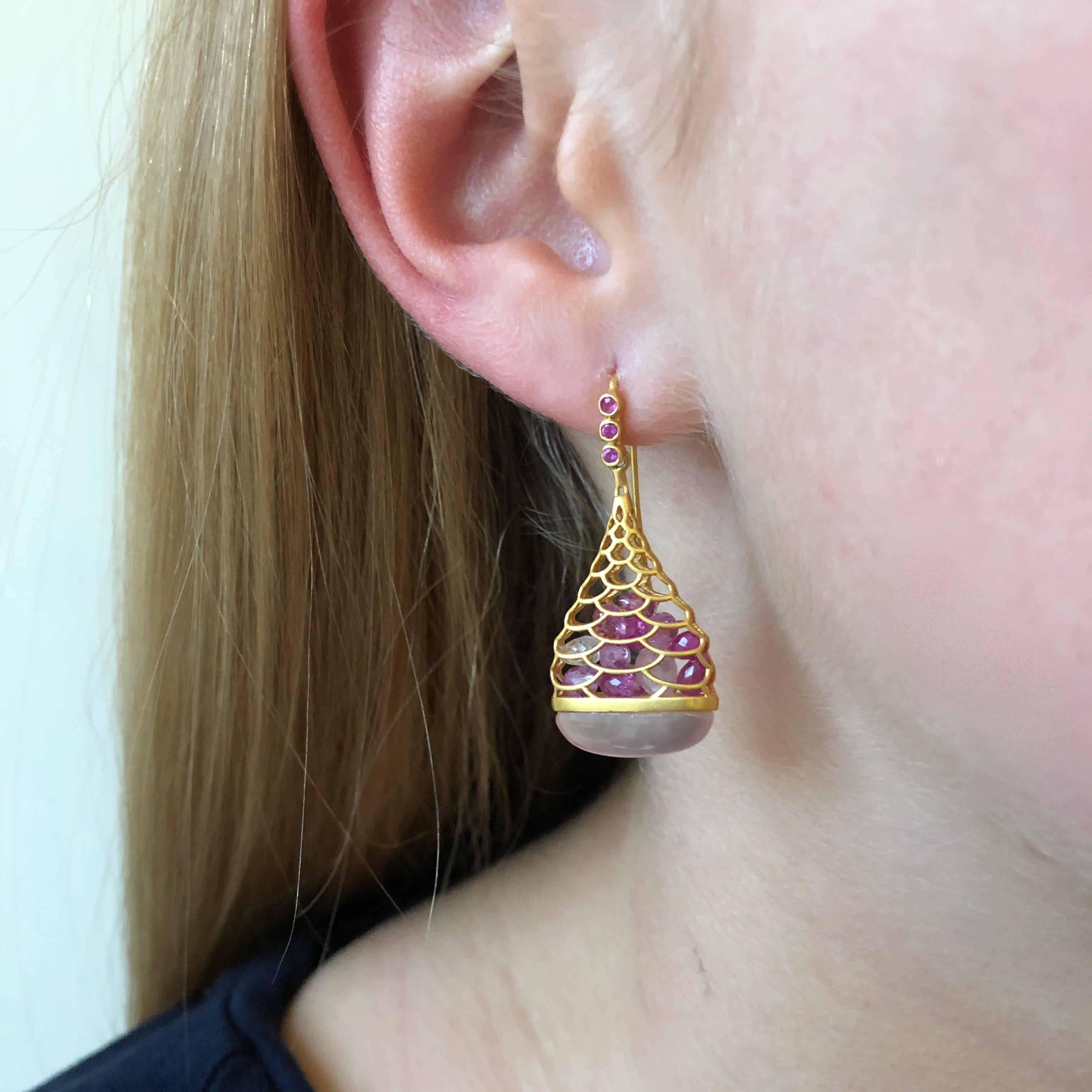 These Lauren Harper Pink Sapphire and Rose Quartz earrings are as unique as they come, with floating loose faceted pink sapphires inside an 18kt Gold Cage, with luminescent rose quartz at the bottom.  Finished in Lauren Harper's signature matte