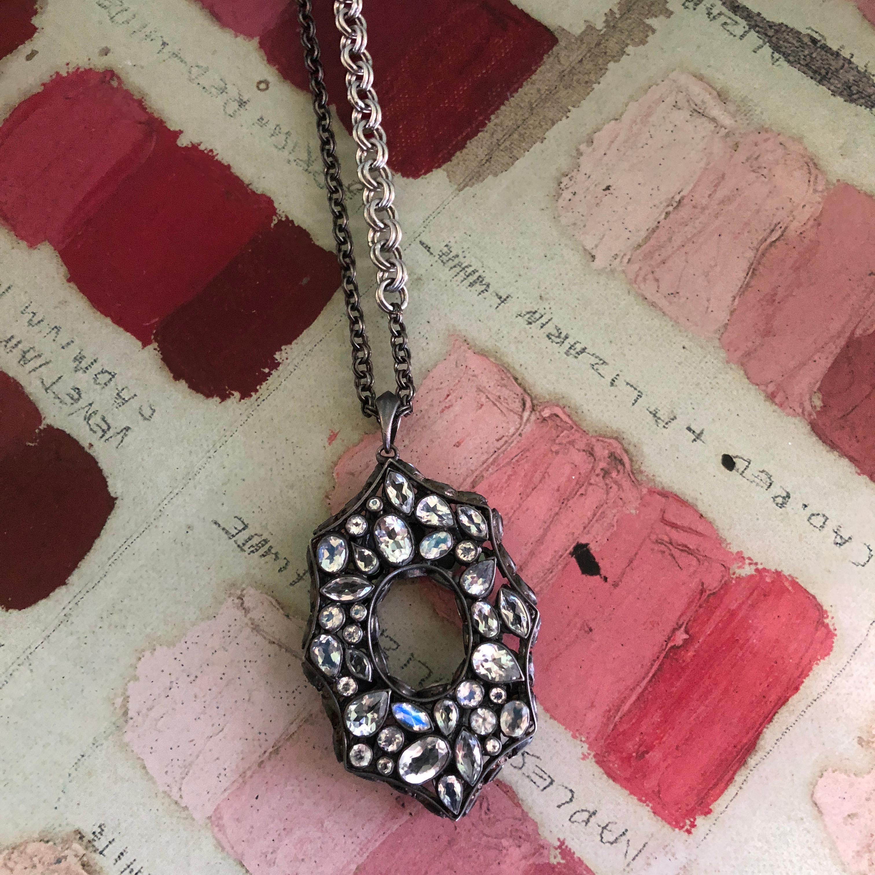 Inspired by the architecture of the 1920's, this reversible pendant has faceted black Spinel on one side, and Rainbow Moonstone on the other side, with side detailing as well.  This pendant is finished in Lauren Harper's signature black rhodium