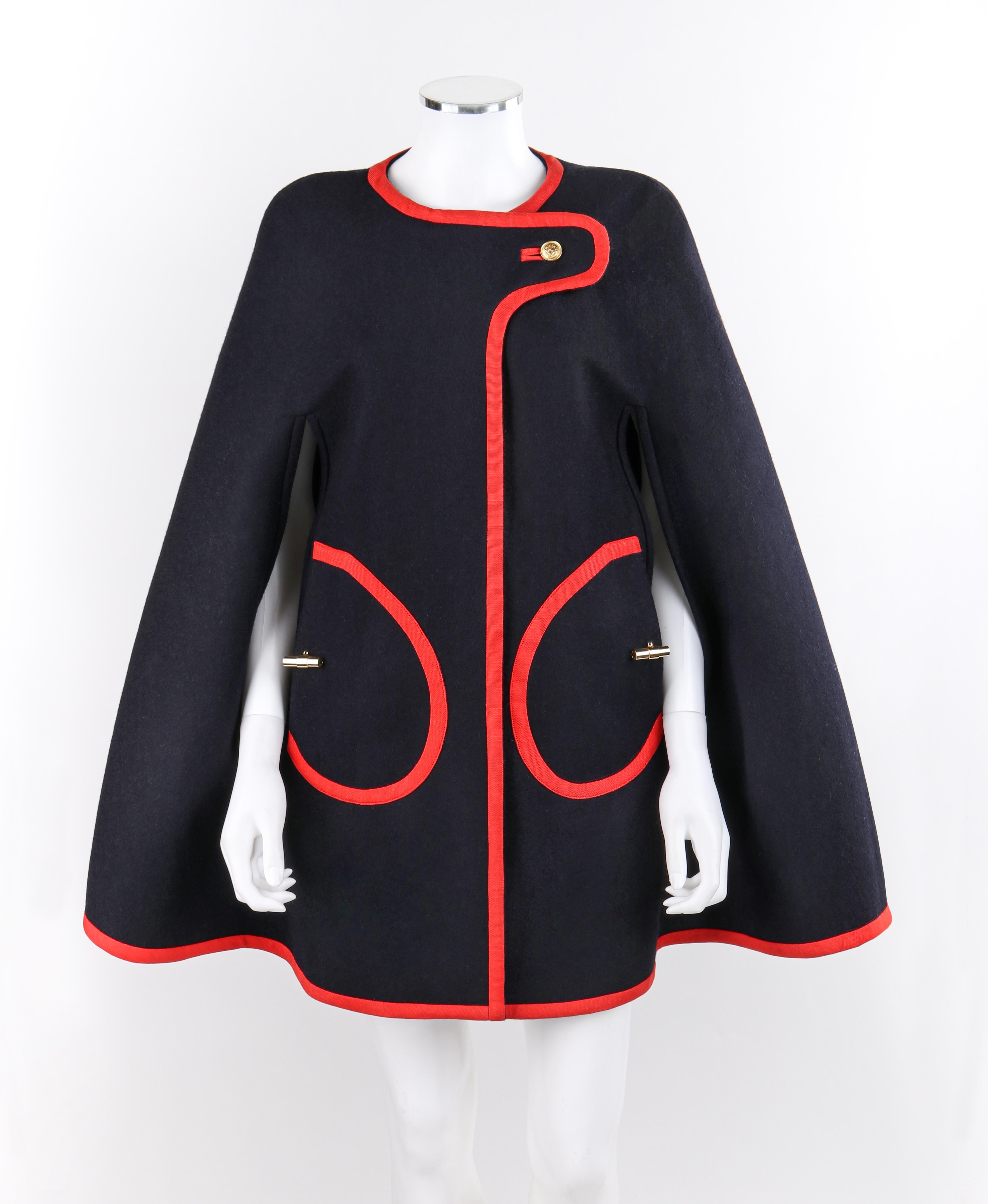 LAUREN MOFFATT F/W 2010 “Cadet” 1960's Navy Blue Red Military Cape Mantel Coat
  
Brand / Manufacturer: Lauren Moffatt
Collection: F/W 2010
Manufacturer Style Name: “Cadet Cape”  
Style: Cape coat
Color(s): Navy blue, red
Lined: Yes
Marked Fabric