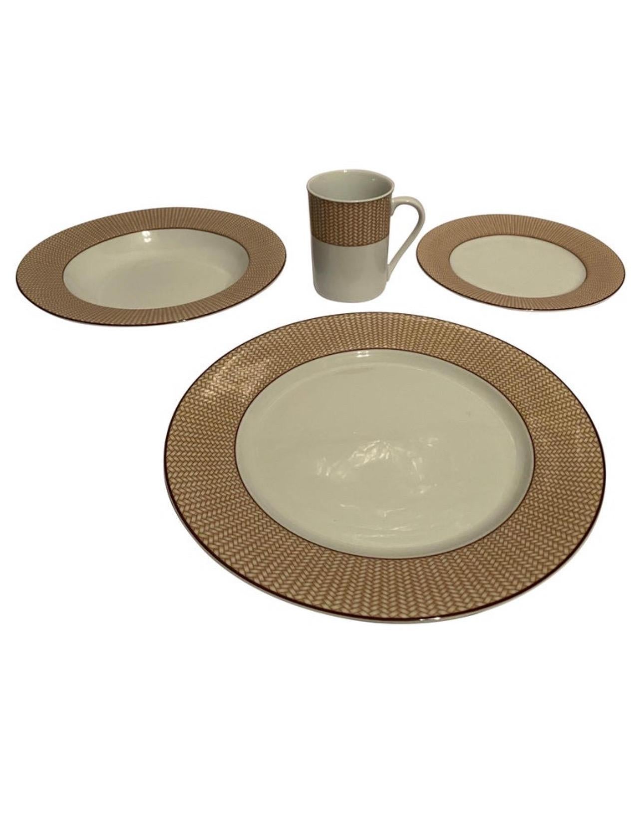 A 24 (twenty-four) piece set of dinnerware by Lauren/Ralph Lauren in the Reed Natural pattern.

Features a tan wicker patterned border on white complemented by brown trim.

Includes the following 24 pieces:
4 Dinner plates
4 Salad plates
8 Rimmed