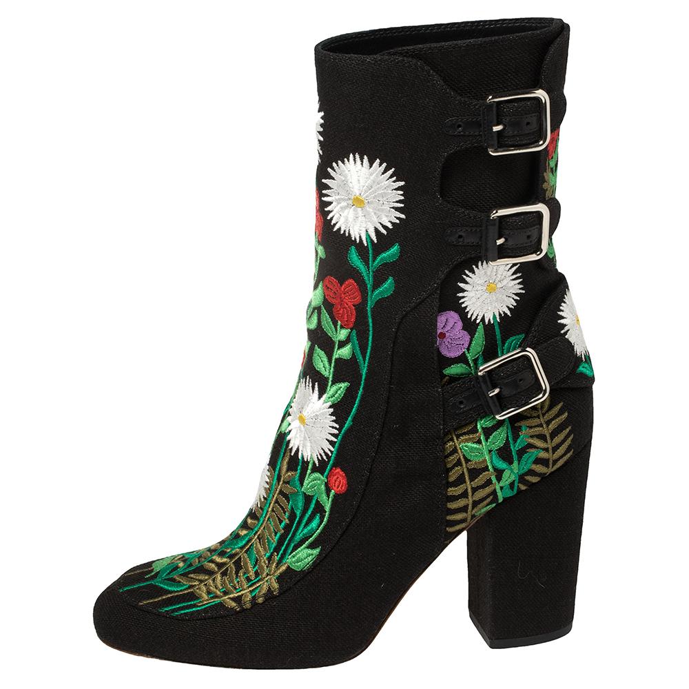 Laurence Dacade's exquisite craftsmanship adorns these one-of-a-kind boots! Crafted from canvas in a black shade, it features brightly hued intricate embroidery throughout the creation. They feature almond toes, buckles, and are set on low block