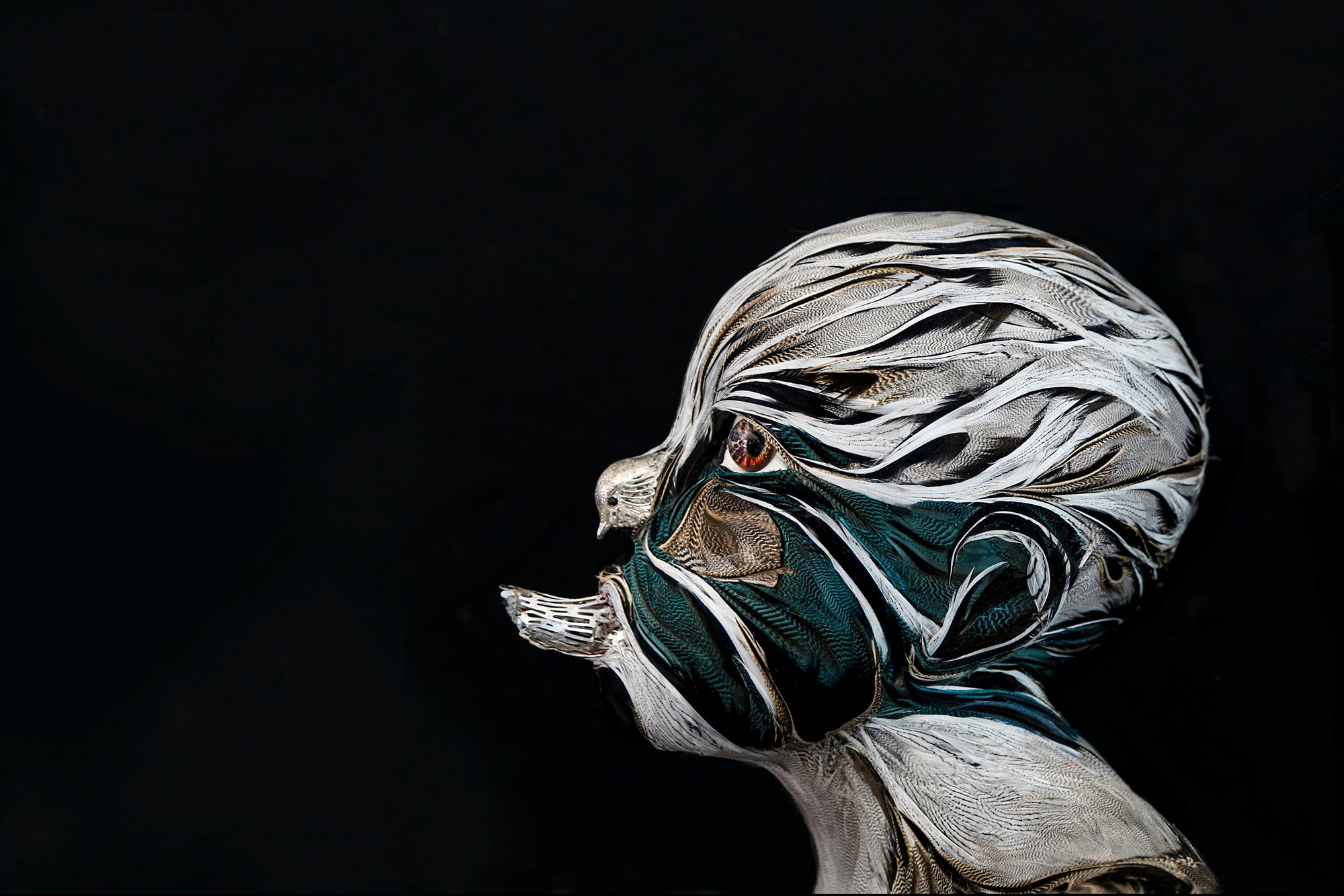 T H E M I S (the child)- 2019 Unique Piece.
H 126 x 47 x 62 cm.
Feathers of pheasant, duck and guinea fowl on poly- propylene. Ceramic feet. bird in silver metal. Eyes in glass and leather.

To create Themis, Laurence Le Constant was inspired by a