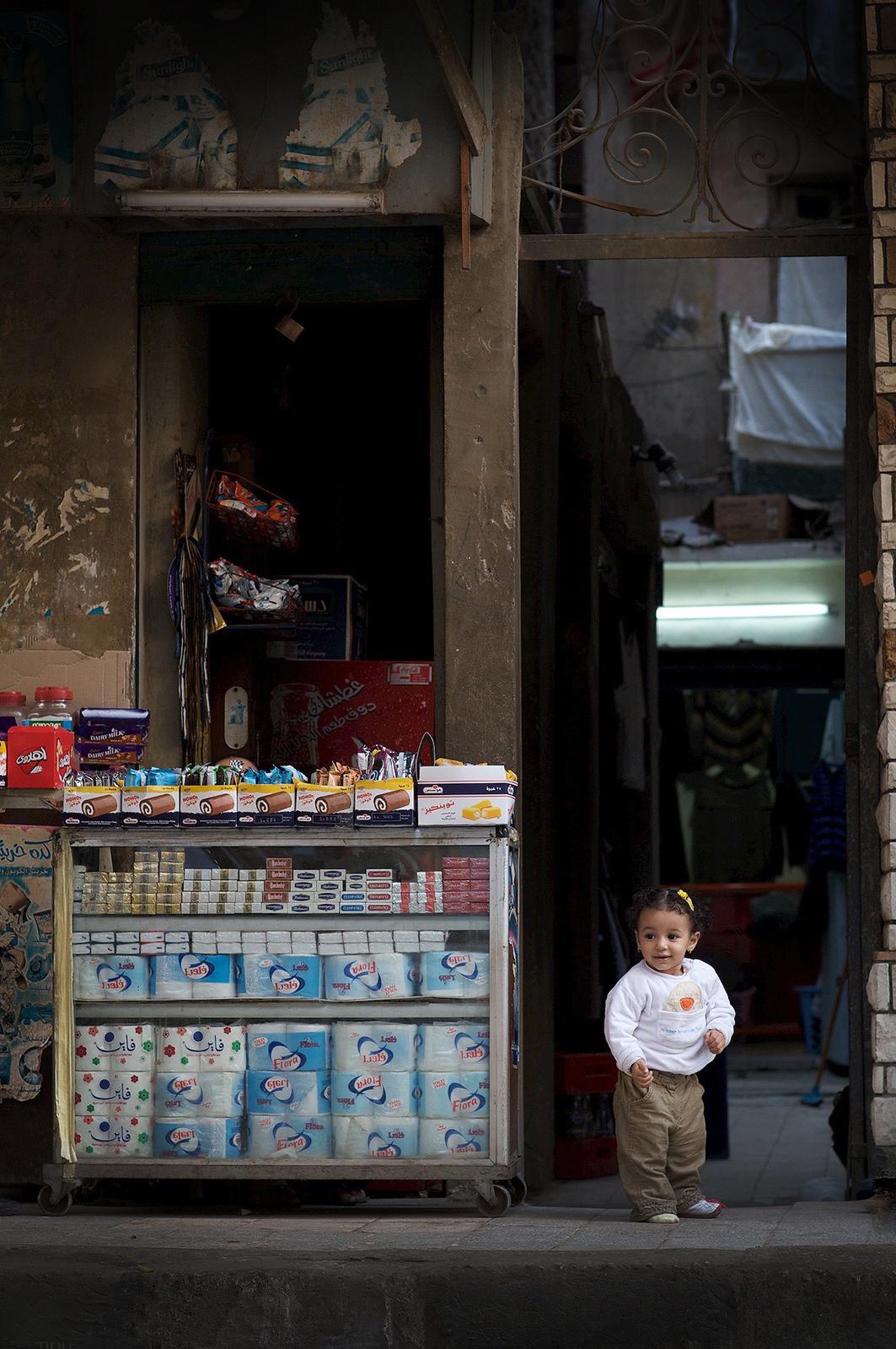 Copts 02 - Signed limited edition archival pigment print, 2012    -  Edition of 5

Little girl at the entrance of a store, in the Coptic Cairo, Egypt, which is a part of Old Cairo which encompasses the Babylon Fortress, the Coptic Museum, the