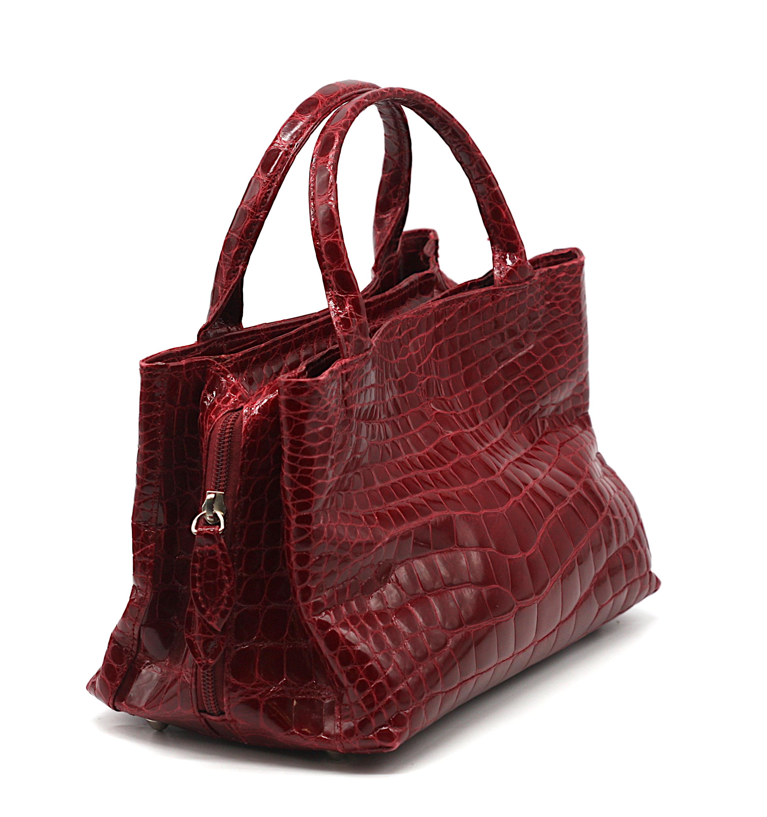 Laurent Effel Ruby Red Alligator Handbag

An elegant and rare example of Laurent Effel’s craftsmanship, this Ruby Red Alligator Handbag exudes timeless sophistication. The structured rectangular silhouette is fashioned from gleaming alligator skin,
