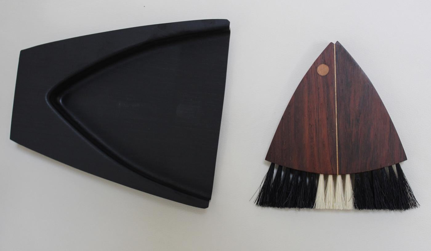 If you're looking for a unique and stylish addition to your table accessories, look no further than this Danish midcentury rosewood fish-shaped table brush. Designed by the renowned Laurids Lonborg, this crumb sweeper features graphical, pure design