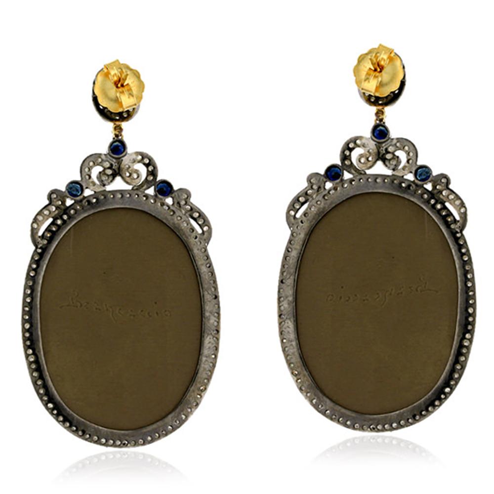 Hand Carved Lava Cameo Earring with Diamonds set in Gold and Silver is a statement earring, which reminds you of romans.

Closure: Push Post

18kt:2.04gms
Diamond:2.71cts
Lava Shell Cameos:113Cts
Blue Sapphire:2.05Cts
