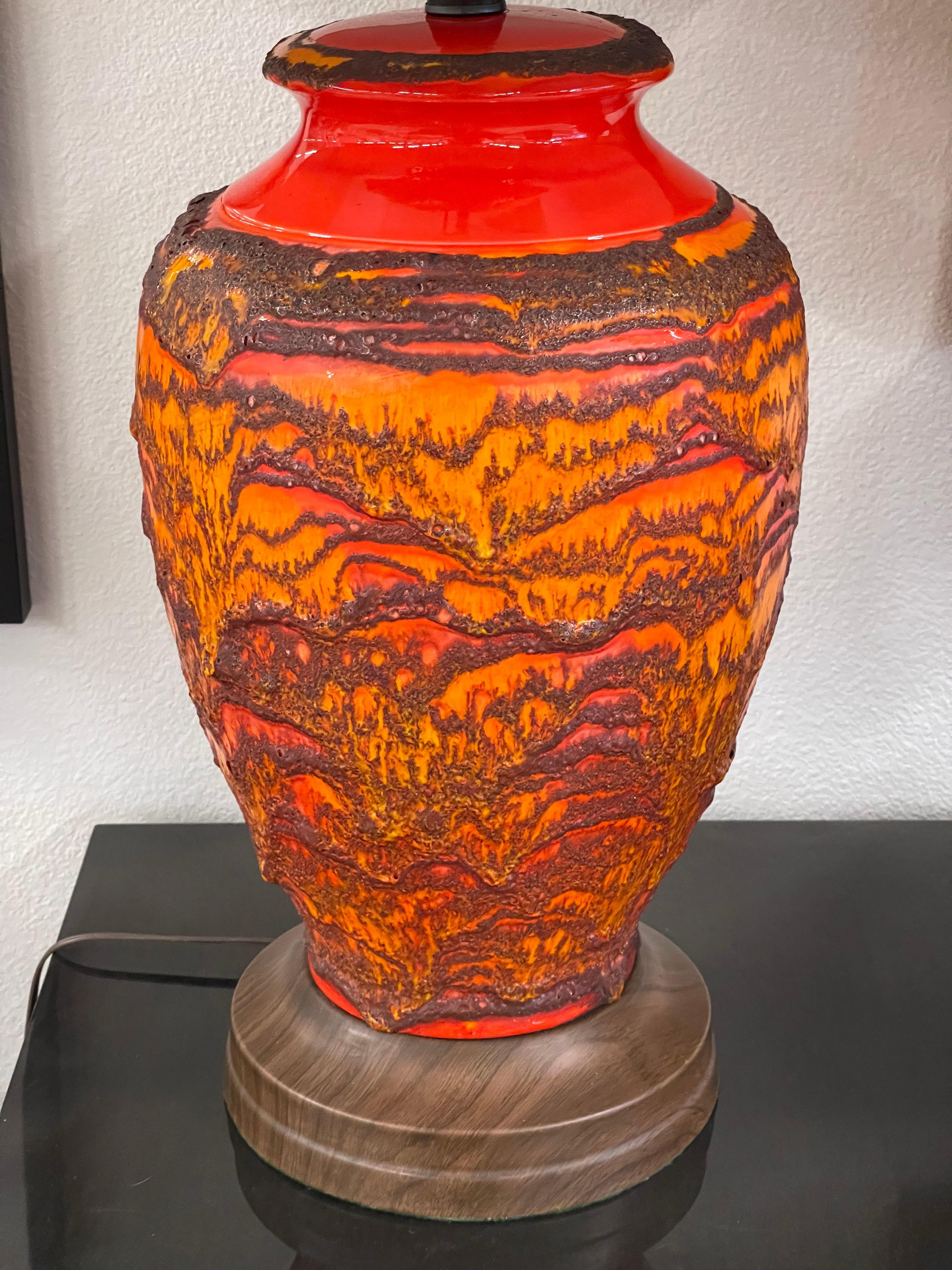 A great pair of vintage ceramic lamps in a Lava Glaze. Bright orange and red, these have just been re-wired with new electrical fittings. The base and green felt are original. Likely West German, possibly Scheurich Keramik, these are massive. The