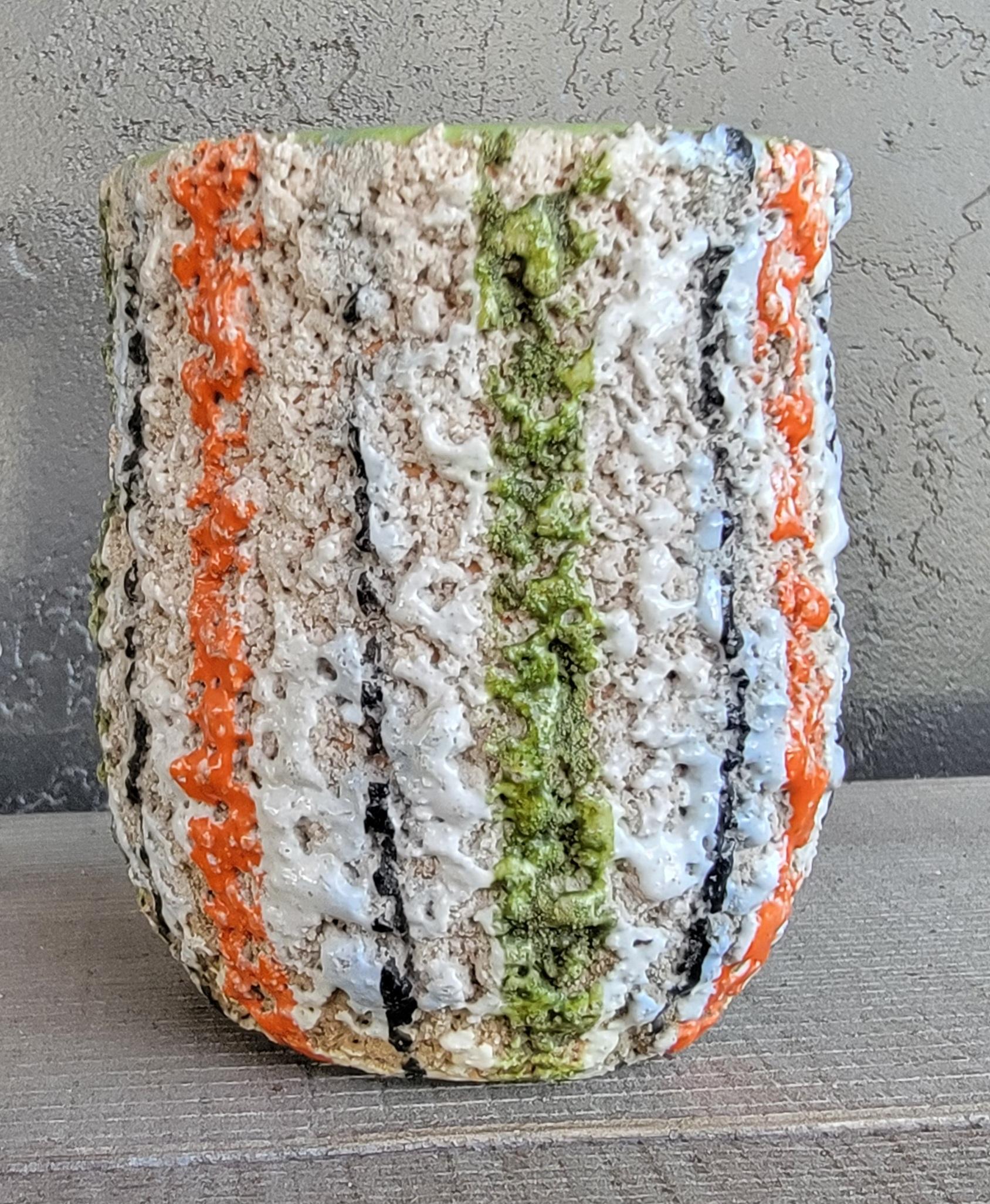 A small pottery vase / planter with a very bubbly and colorful lava type glaze.
Appears to be either West Germany or Italy? Circa. 1960's 70's.

4.25 inches high.
3.5 inch diameter.