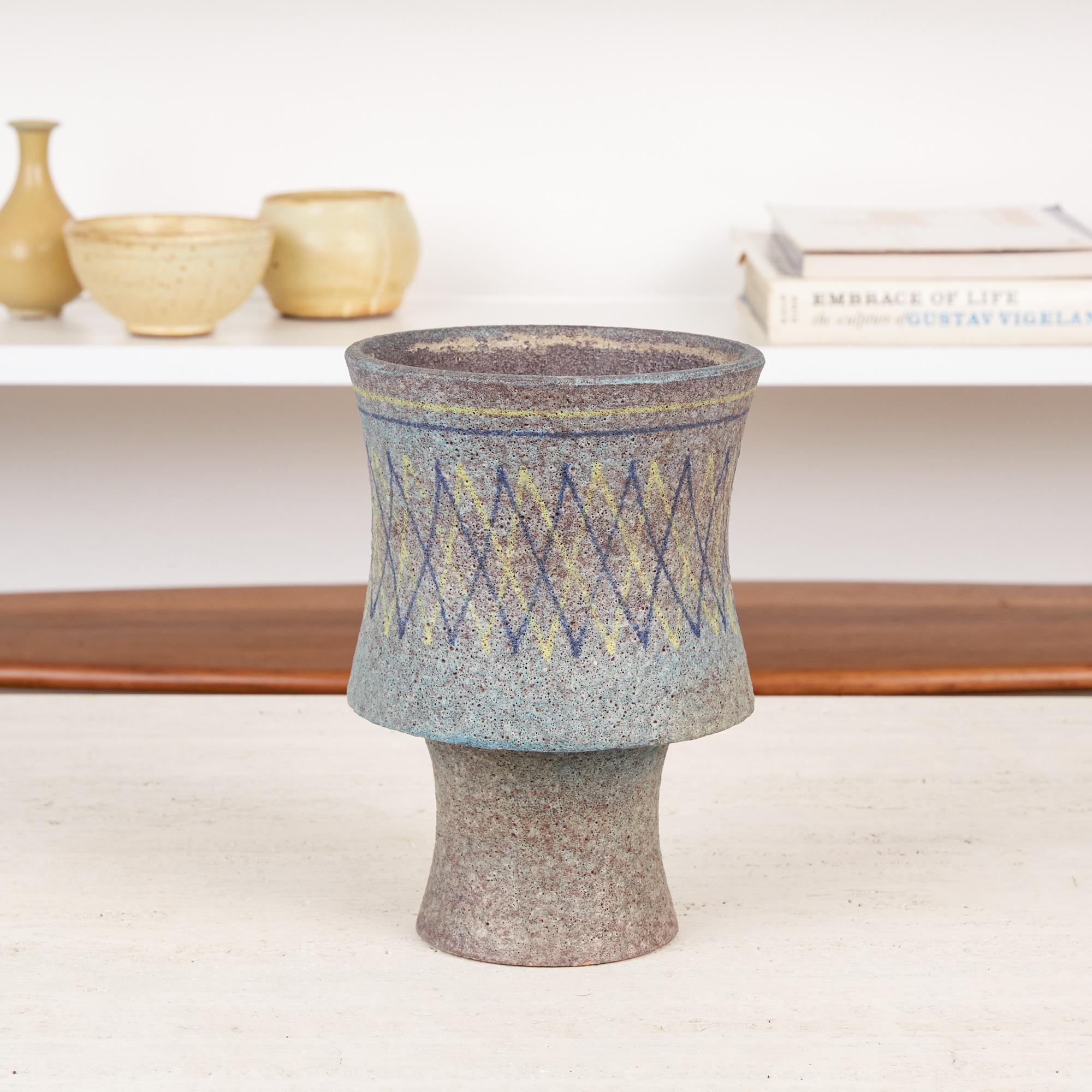 Ceramic chalice vase by Aldo Londi for Bitossi, Italy, circa 1960s. The vase features a wide curvaceous upper section that sits atop a thinner convex stem. It is covered in a muted turquoise lava glaze with underlying lavender accents. The upper