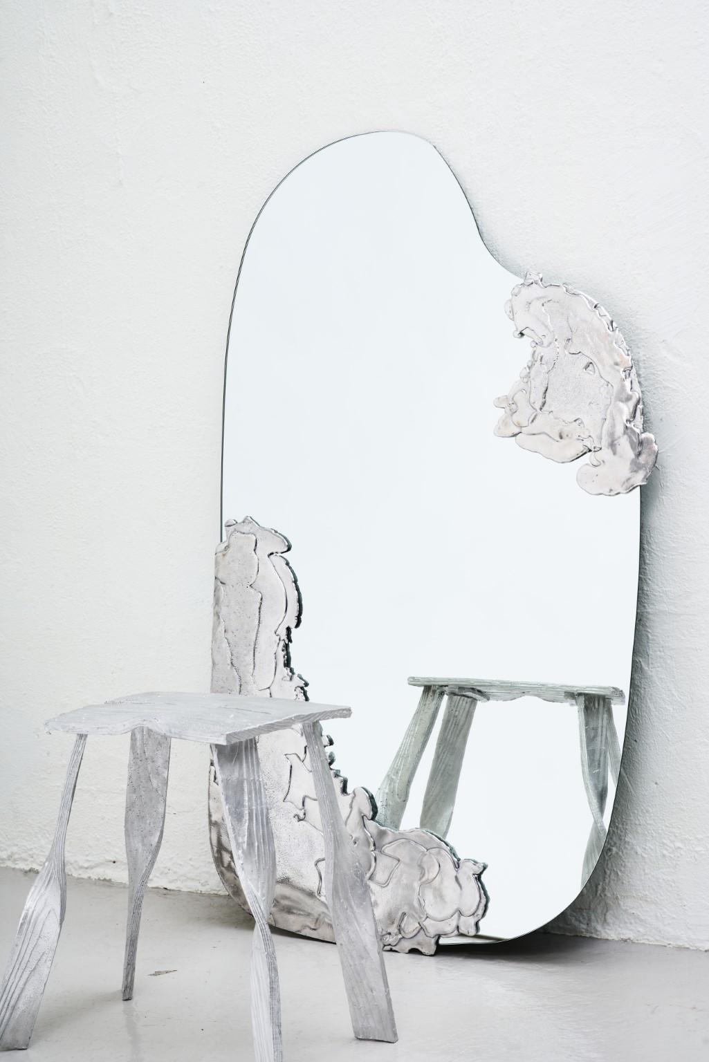 Lava mirror by Andredottir & Bobek
Dimensions: W 130 x H 70 cm
Materials: Mirror with aluminum
The lava mirror is handcrafted and one of a kind.

It is first shaped in vax and is subsequently cire perdue casted in aluminum which looks like floating