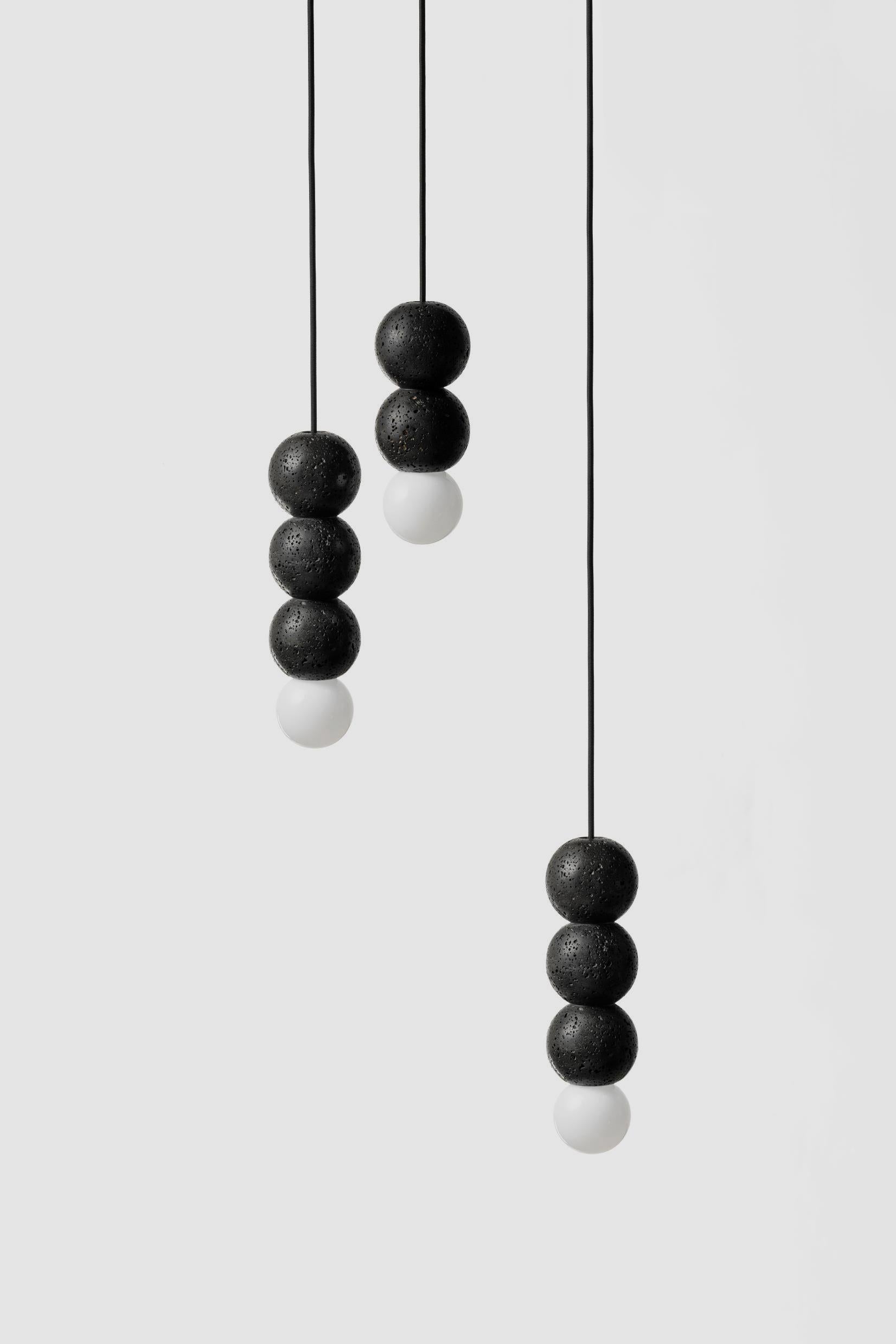 Material: Lava Stone
Fittings: Black Aluminum
Color: Black
Dimension: 90 x 90 x 320 mm
Weight: 1.4 kg
Cord: 3000 mm
Light Source: E27 G80
CCT: 3200 K
CRI: 85 Ra
Flux: 600 lm
Supply: 220 V
Wattage: 7 W

About the Artist/ Designer:
The word “buzao”