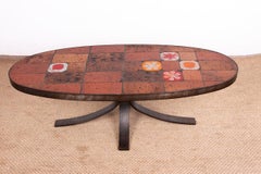 Table basse en pierre de lave, céramique et acier, créée par Jean Jaffeux, 1960.