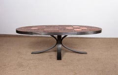 Table basse en pierre de lave, céramique et acier, créée par Jean Jaffeux, 1960.
