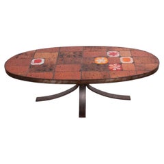 Table basse en pierre de lave, céramique et acier, créée par Jean Jaffeux, 1960.