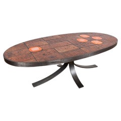 Table basse en pierre de lave, céramique et acier, créée par Jean Jaffeux, 1960.