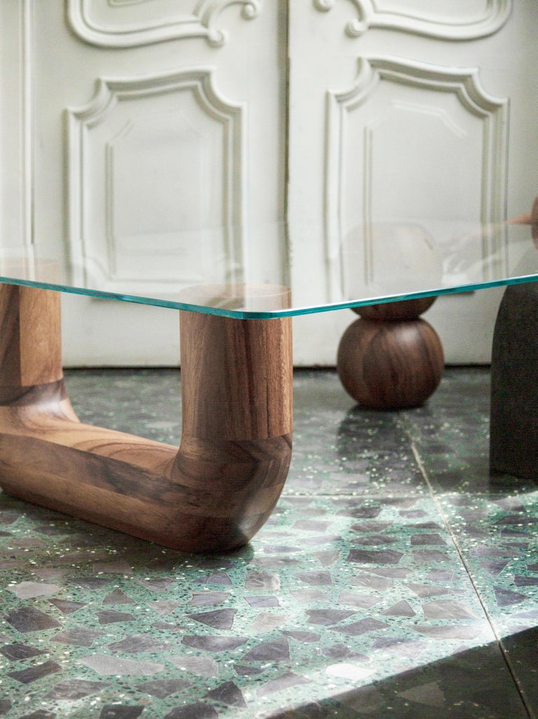 The Rosedal table is a sculptural coffee table assembled by three pieces. Two hand-shaped in Huanacaxtle solid wood and the other in volcanic stone; the top in glass lays down above, framing them.

We are Comité de Proyectos, an interior and
