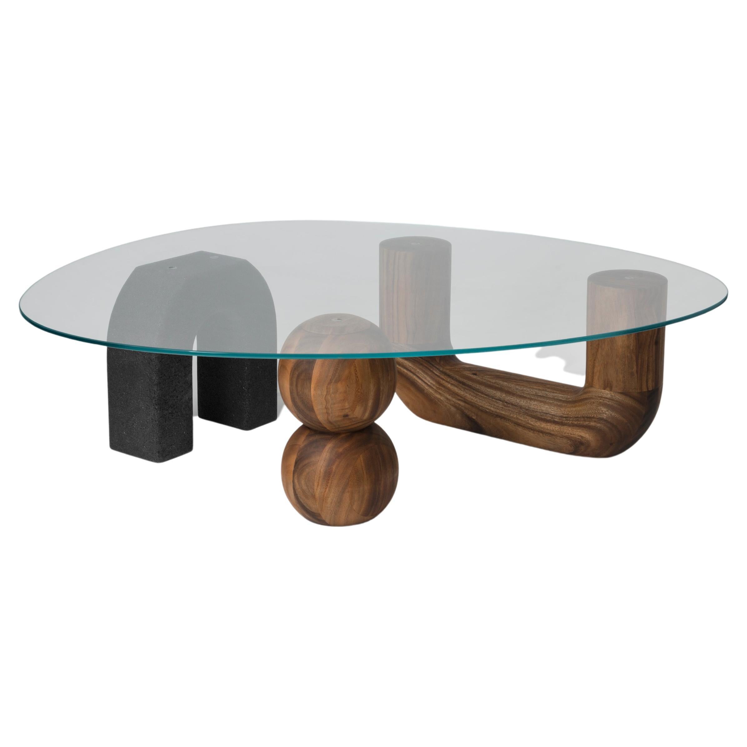 The Rosedal table is a sculptural coffee table assembled by three pieces. Two hand-shaped in Huanacaxtle solid wood and the other in volcanic stone; the top in clear glass lays down above, framing them.
*Can be sold without the glass cover (only the