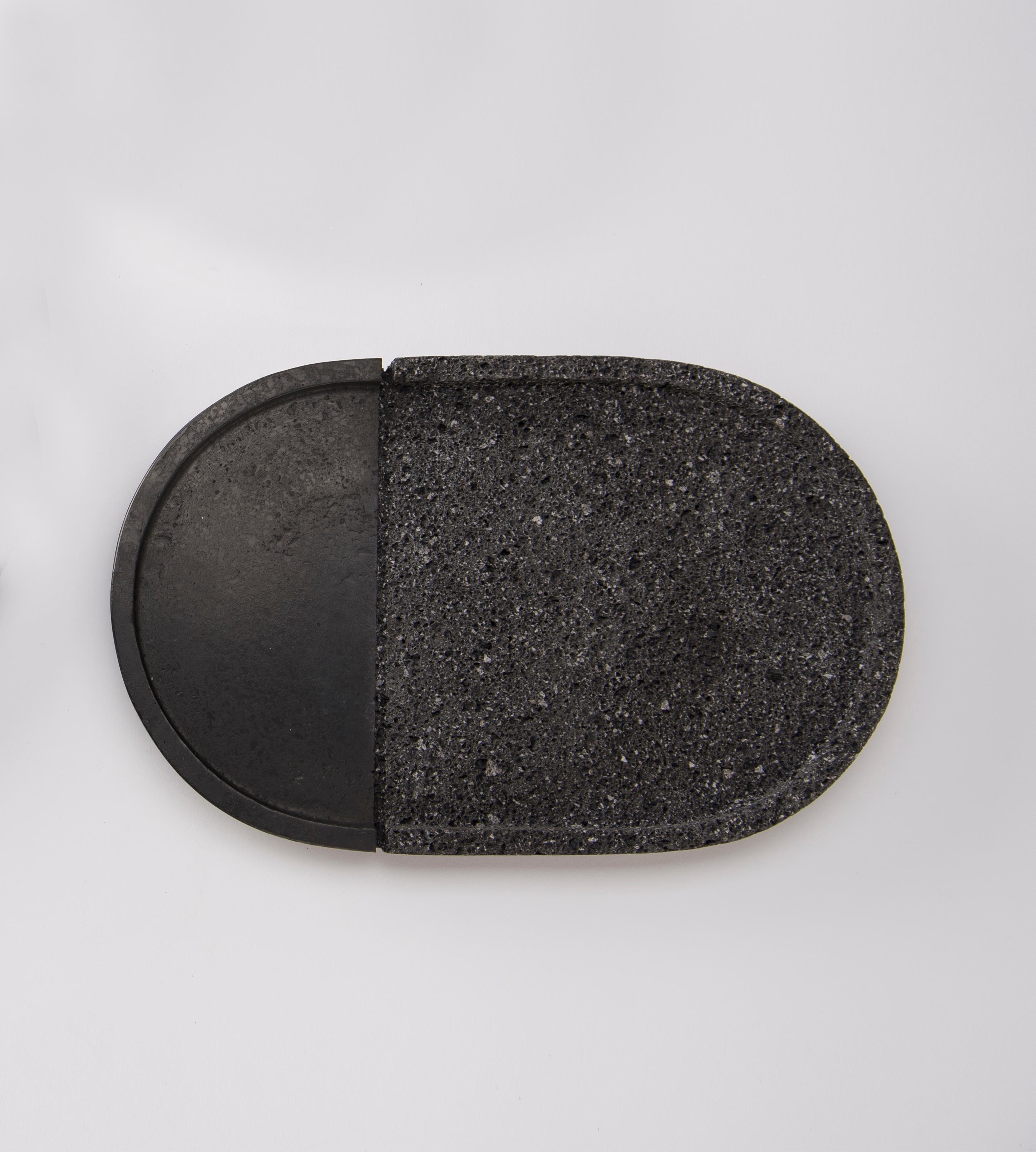 Volcanic stone is a witness to the power of nature: hand-polished by craftsmen with a millenary tradition, its unruly nature is transformed into a sensible and human object. With their Dual texture, the collection of lava plates is as much an homage