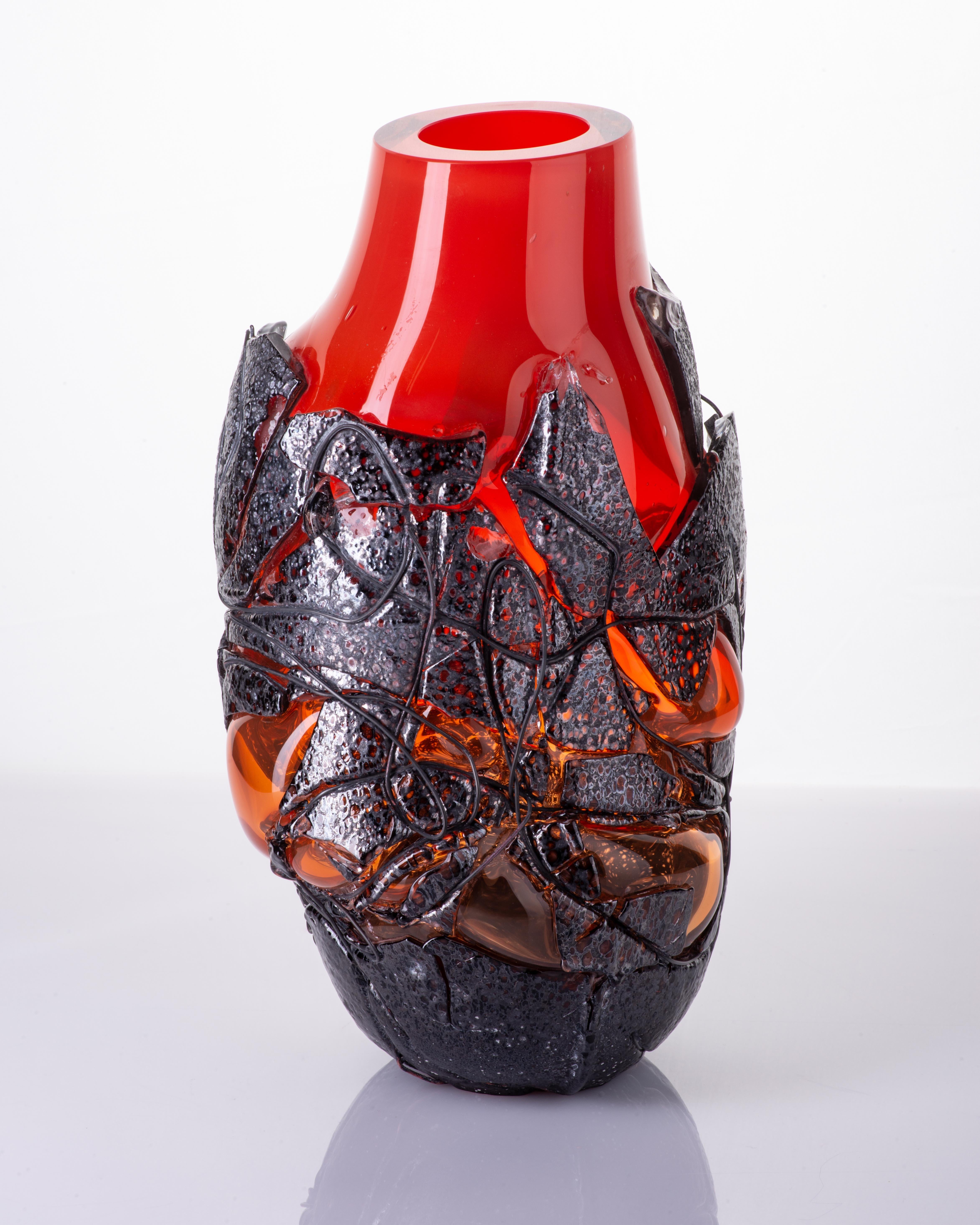 The Lava vases are an extension of the approach to colour and dimension that Anna Jožová has taken with the Keto series. They are a combination of two layers of glass and copper wire, where the flow of enamel through the modeled copper wire gives