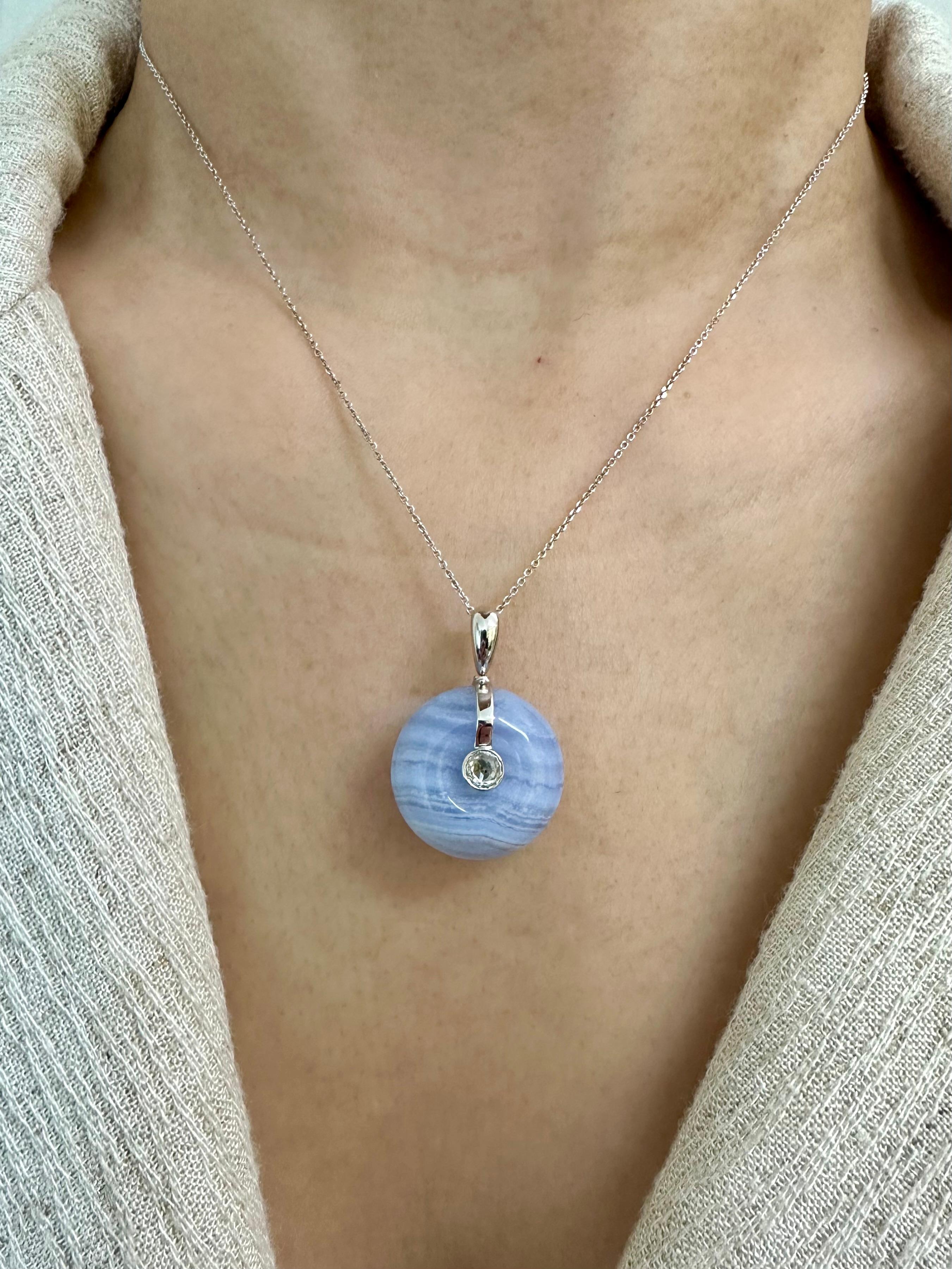Please check out the HD video. This pendant can be worn on both sides for a different look. The pendant is set in 18k white gold. The lavender Agate which is also a type of Chalcedony is about 1.8cm in diameter and weights 20.47 Cts . The natural