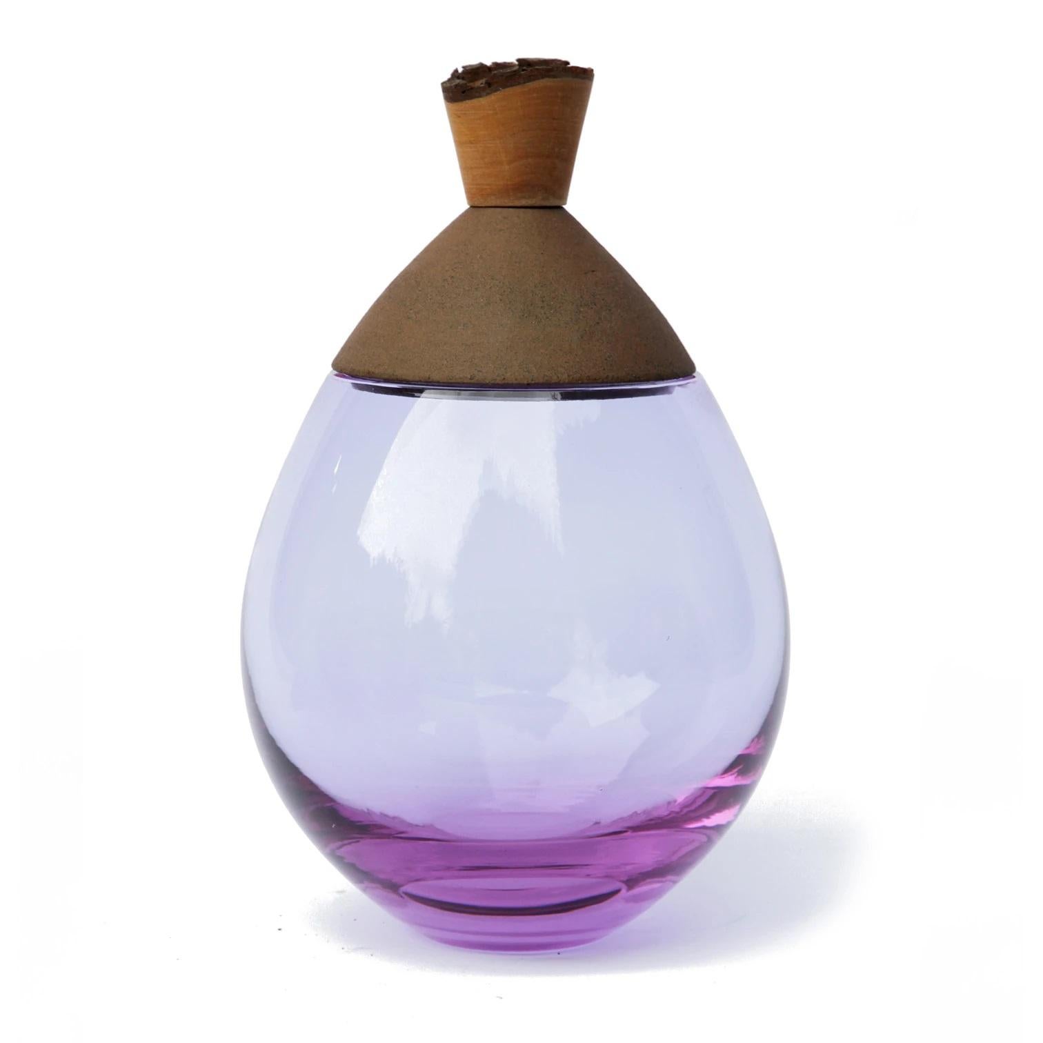 Lavender and brown Satu stacking vessel, Pia Wüstenberg
Dimensions: D 19 x H 23
Materials: glass, wood, ceramic
Available in other colors.

Handmade in Europe: handblown glass (Czech Republic), earthenware ceramic (Germany), hand turned wood