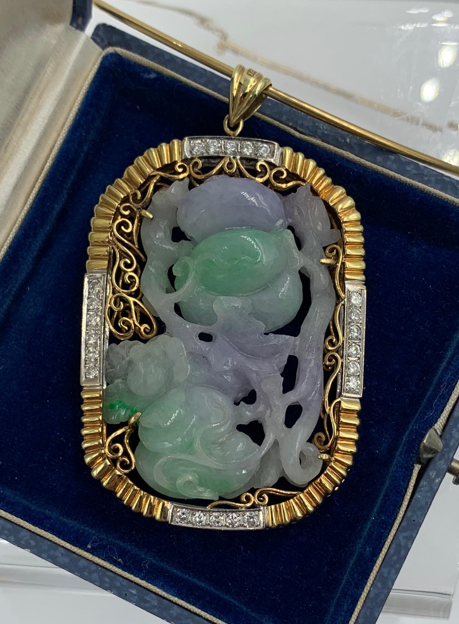 This is a spectacular two sided Antique Jade Diamond Necklace with a magnificent 2 3/4 inch pendant with a carved Lavender and Green Jade in a flower and fruit motif of great beauty.   The Jade is set in a 14 Karat White and Yellow gold frame which