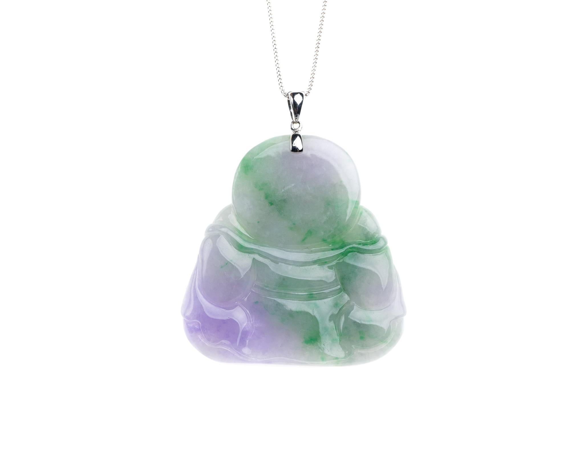 Questo buddha felice scolpito in giada verde e lavanda, completamente naturale, è incastonato in oro bianco 18 carati.  

Il buddha di giada misura 1,87 pollici (47,6 mm) x 1,95 pollici (49,6 mm) con uno spessore di 0,36 pollici (9,1 mm).

È incluso