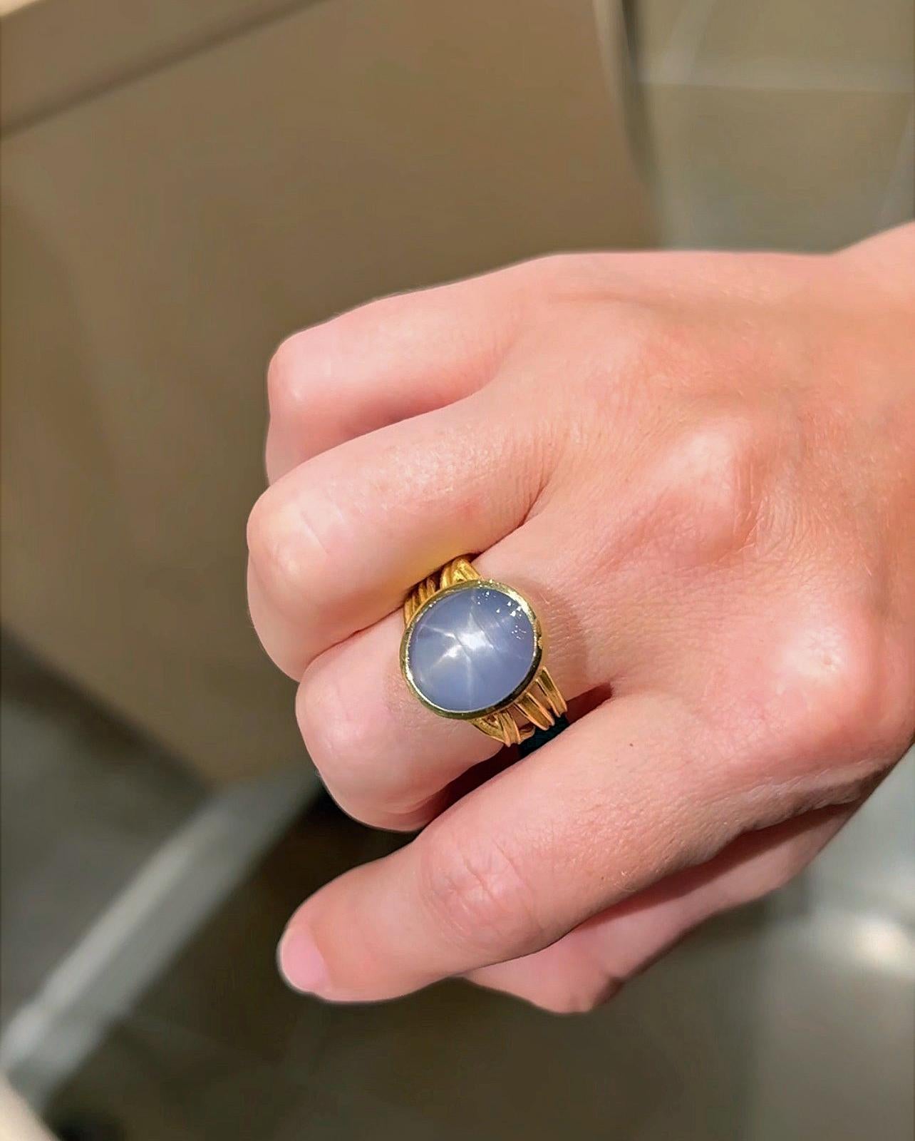 One of a Kind Ribbon Wrap Ring handmade by award-winning jewelry designer Barbara Heinrich featuring an extraordinary lavender blue 9.47 carat gem oval star sapphire cabochon with phenomenal asterism in the form of a six ray star, bezel-set in