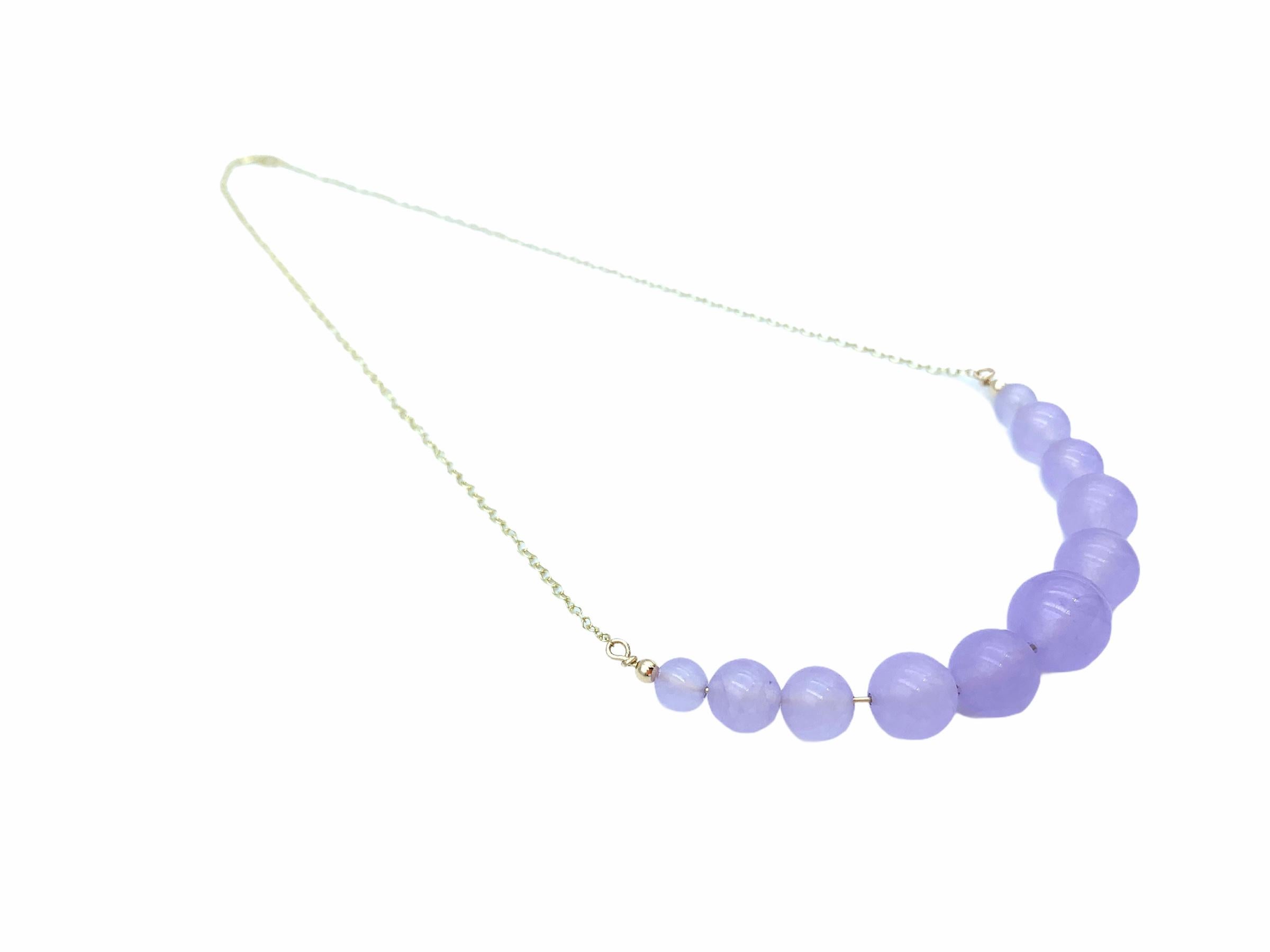 Hand made using 9 carat Yellow Gold, the suspended Lavender Chalcedony beads are threaded together with a solid gold wire and graduated onto a delicate 1.7 mm cable chain. The lovely soft lilac centre bead is 12 mm in size, 10mm the two following, 8