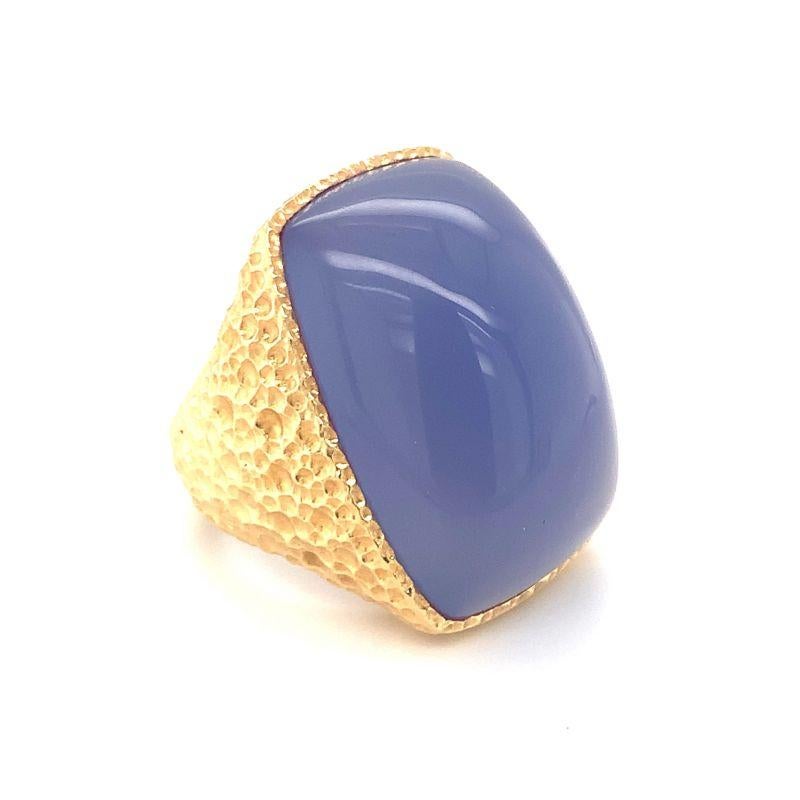 Extravagant lavender chalcedony ring with textured 18K yellow gold finish. Rectangular cabochon cut chalcedony measuring 29 x 20 x 12 millimeters. Grand, fascinating, lustrous.

Additional information:
Metal: 18K yellow gold
Gemstone: Chalcedony =