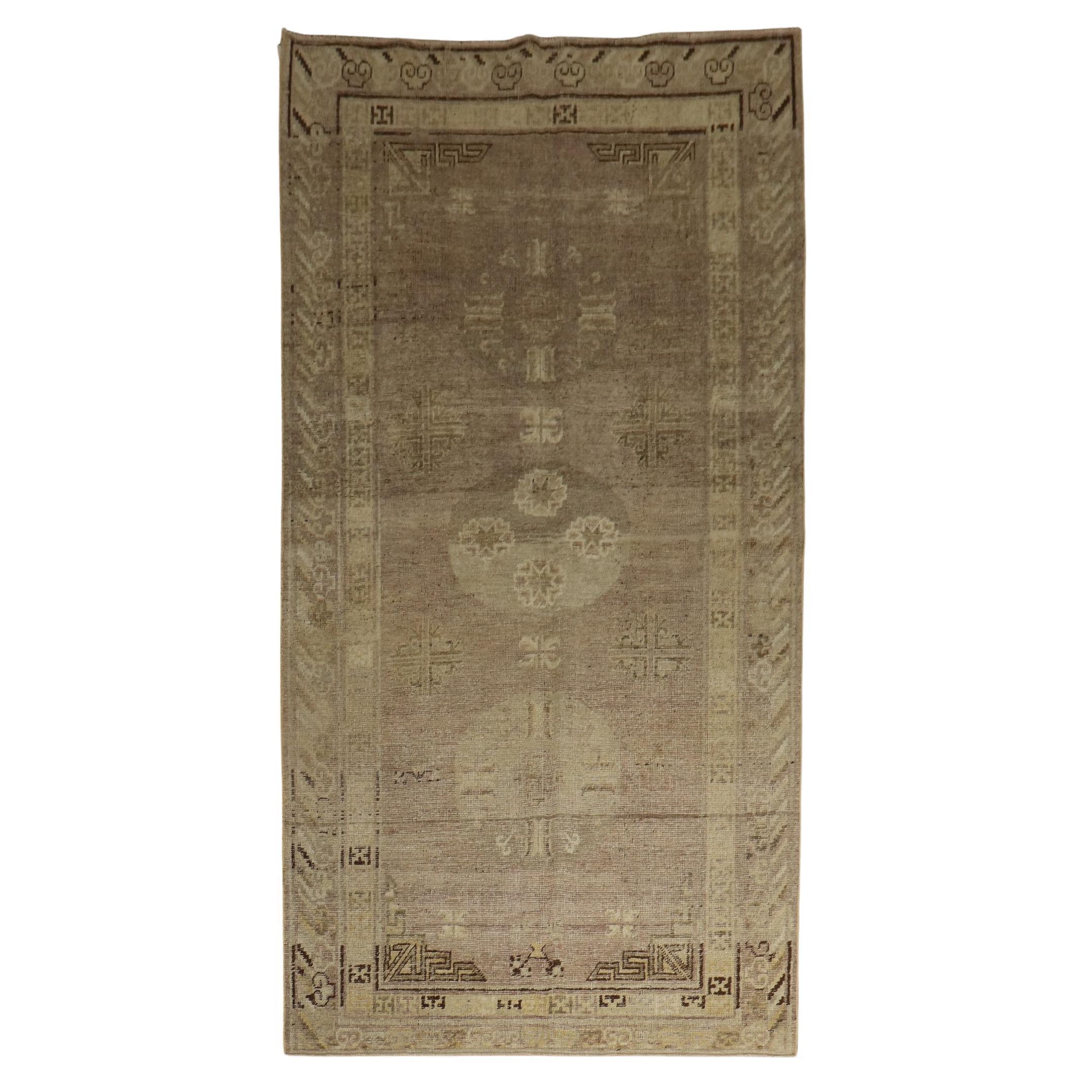 An authentic 19th century East Turkestan Khotan rug with a soft lavender field and dominant accents in gray and brown, circa 1880

Measures: 4'9