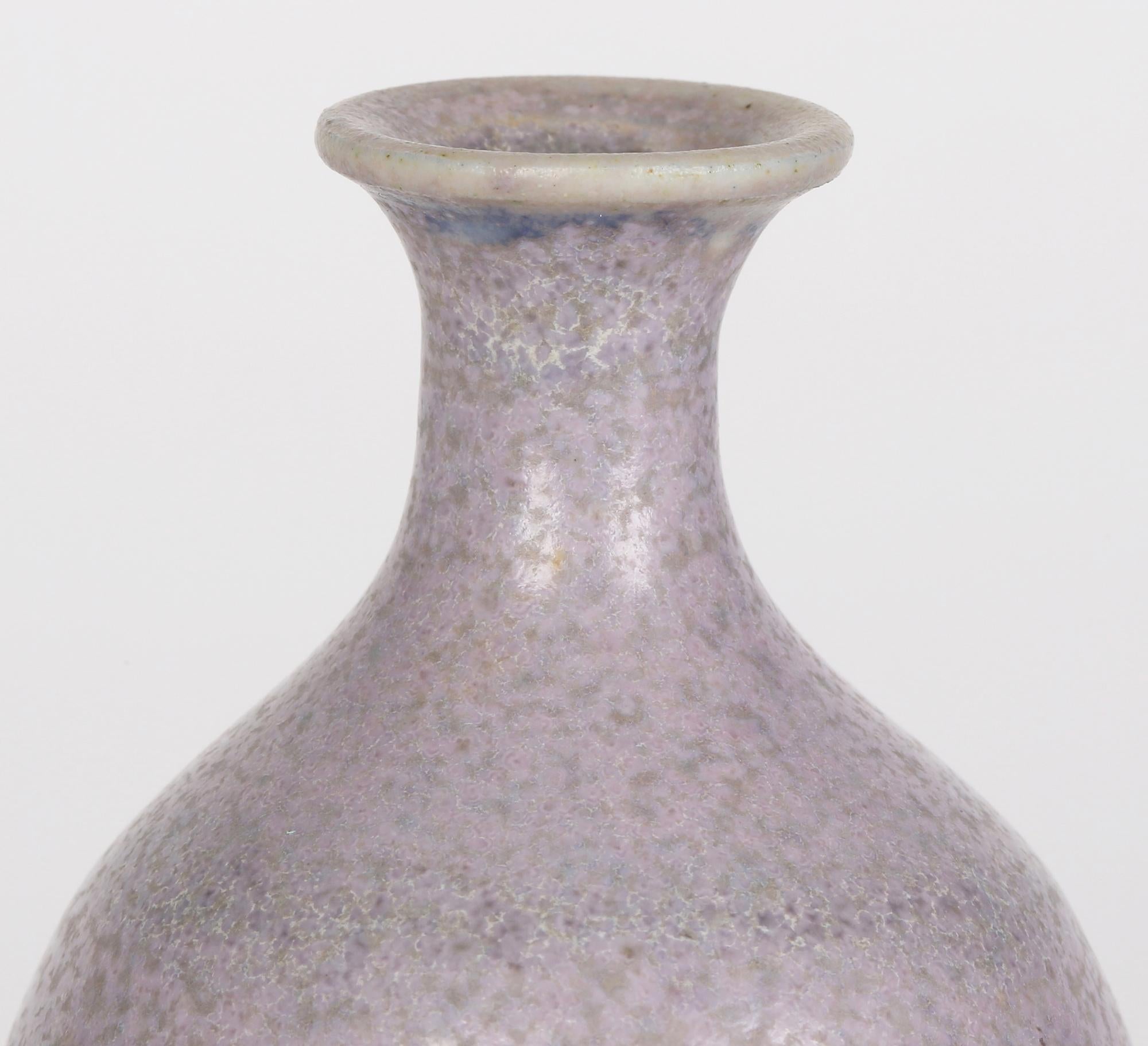 A very fine quality studio porcelain vase decorated in satin lavender hares fur glazes signed ST and in the style of Berndt Friberg dating from the 20th century. The small sized tall bulbous shaped vase stands on a narrow round rim with slightly