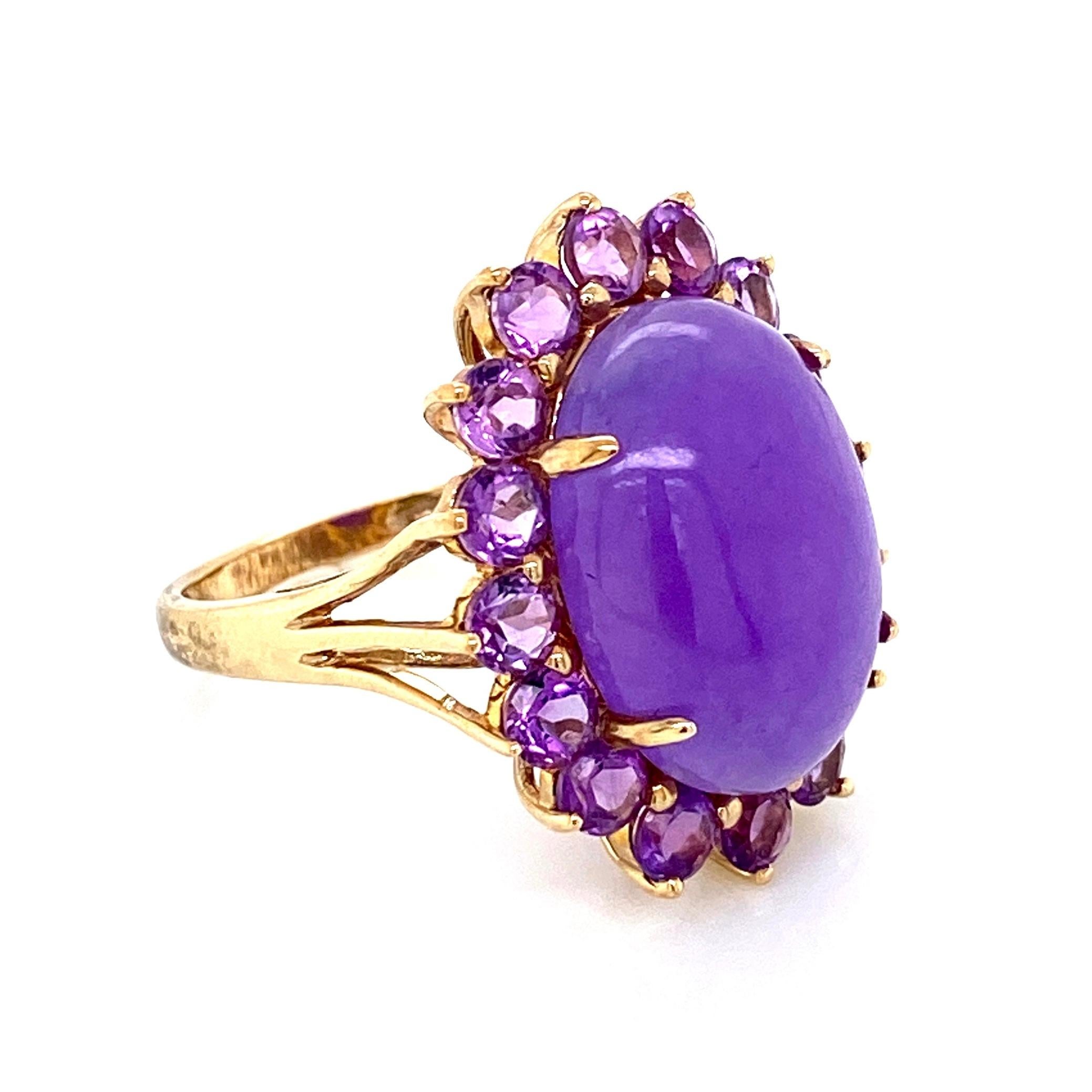 Beautiful and Striking! Elegant and finely detailed Lavender Jade and Amethyst Cocktail Ring. Center set with a securely nestled oval Lavender Jade, surrounded by Amethyst. Measuring approx. 0.74” w x 0.01” h x 1.08” d Hand crafted in 10 Karat