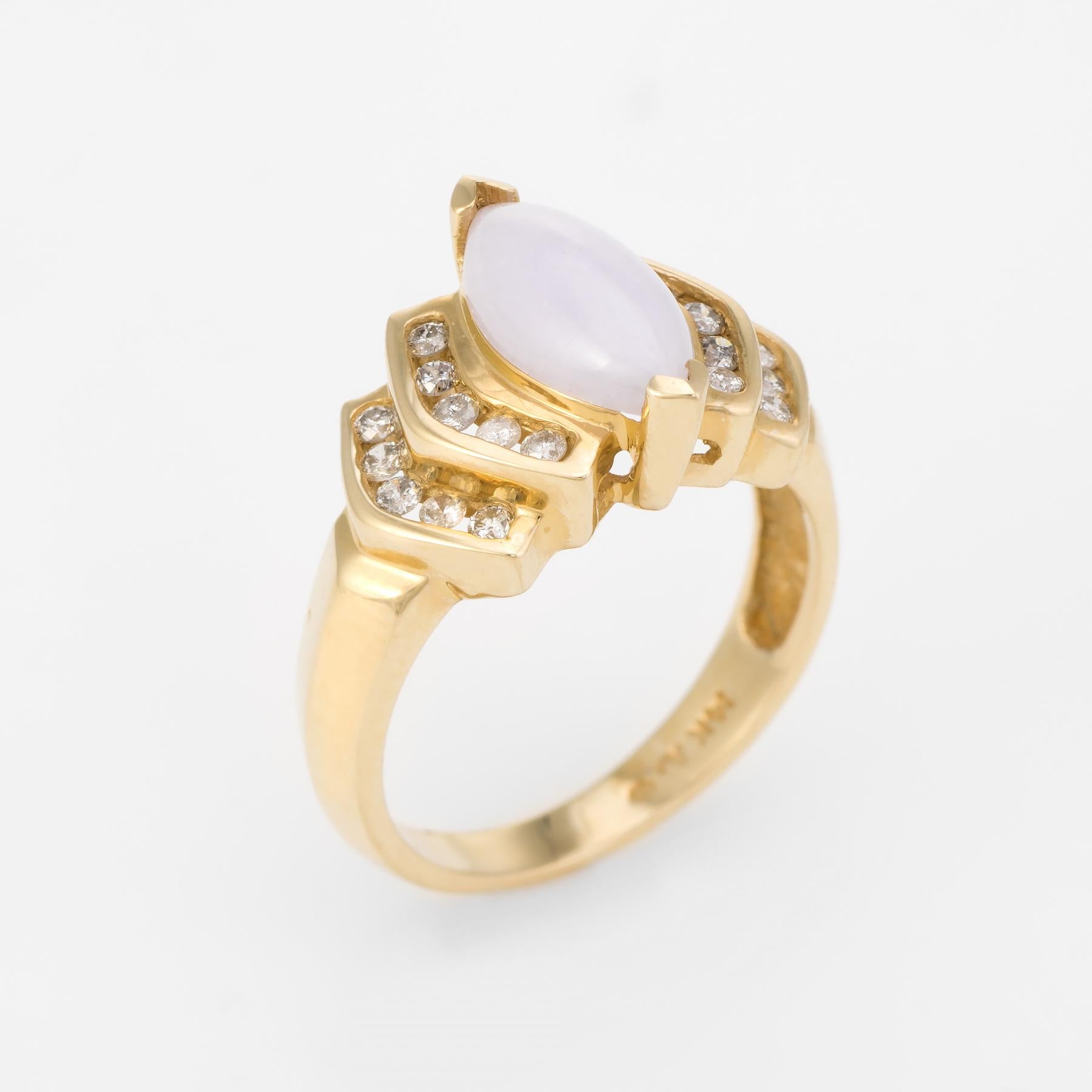 Finely detailed vintage ring, crafted in 14 karat yellow gold. 

Lavender jade measures 12.1mm x 6.4mm (estimated at 2 carats), accented with an estimated 0.20 carats of diamonds (estimated I-J in color and I1-2 in clarity).

The ring is in