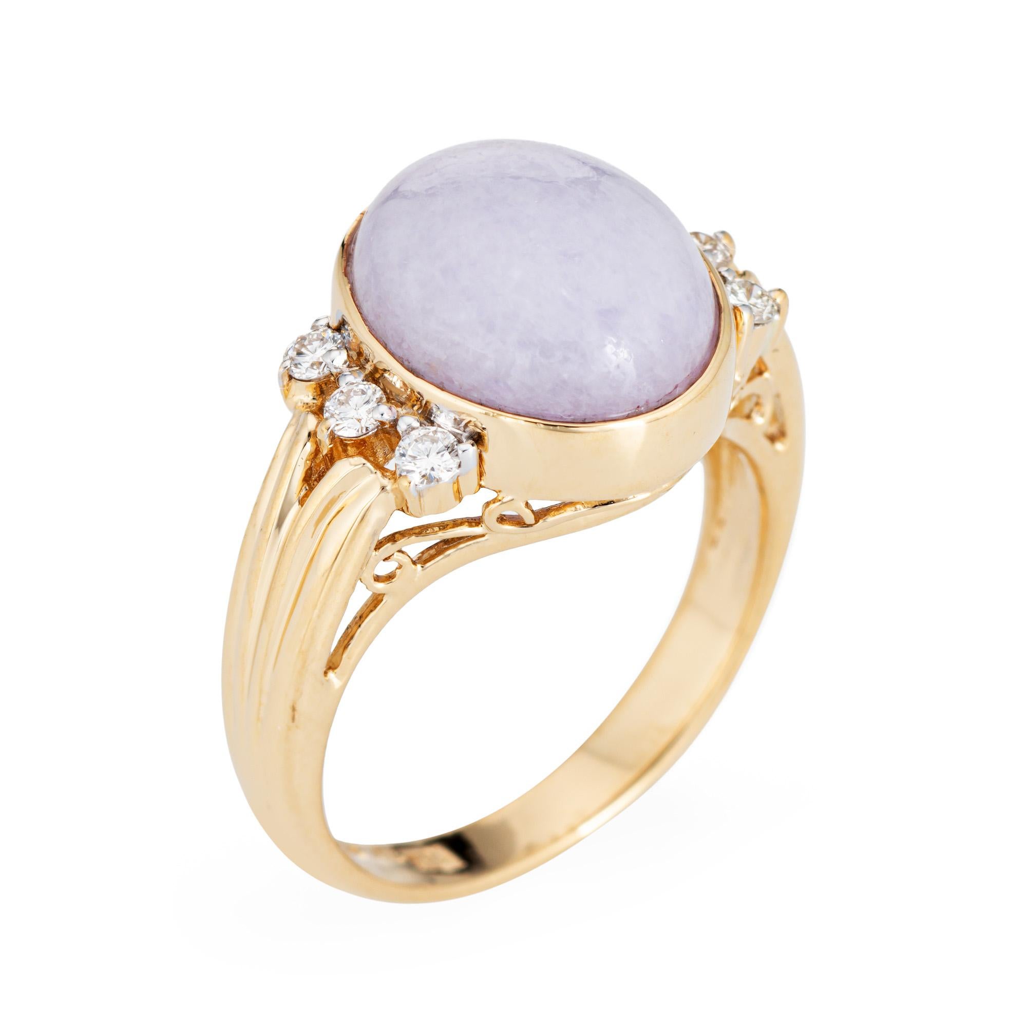 Stylish and finely detailed lavender jade & diamond ring crafted in 14 karat yellow gold (circa 1970s to 1980s).

Cabochon cut lavender jade measures 11.5mm x 10mm (estimated at 6 carats). 6 diamonds total an estimated 0.18 carats (estimated at H-I