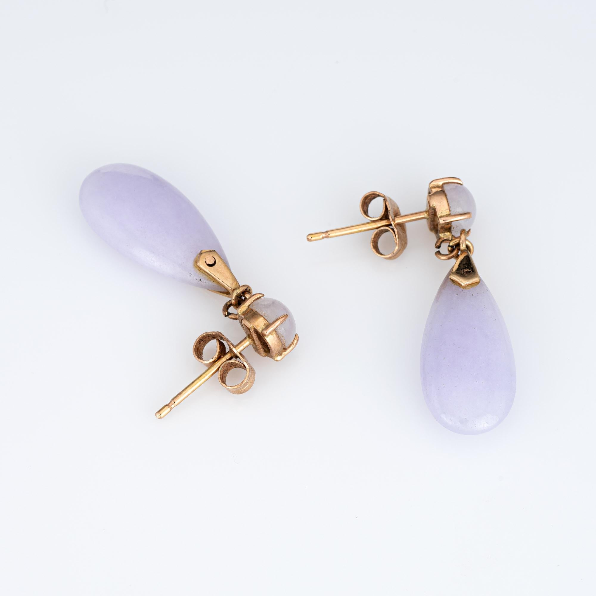 Elegant pair of vintage lavender jade drop earrings (circa 1950s to 1960s) crafted in 14k yellow gold. 

Lavender jade (lower) measures 18mm x 8.5mm. The round jade (upper) measures 5mm. The jade is in excellent condition and free of cracks or