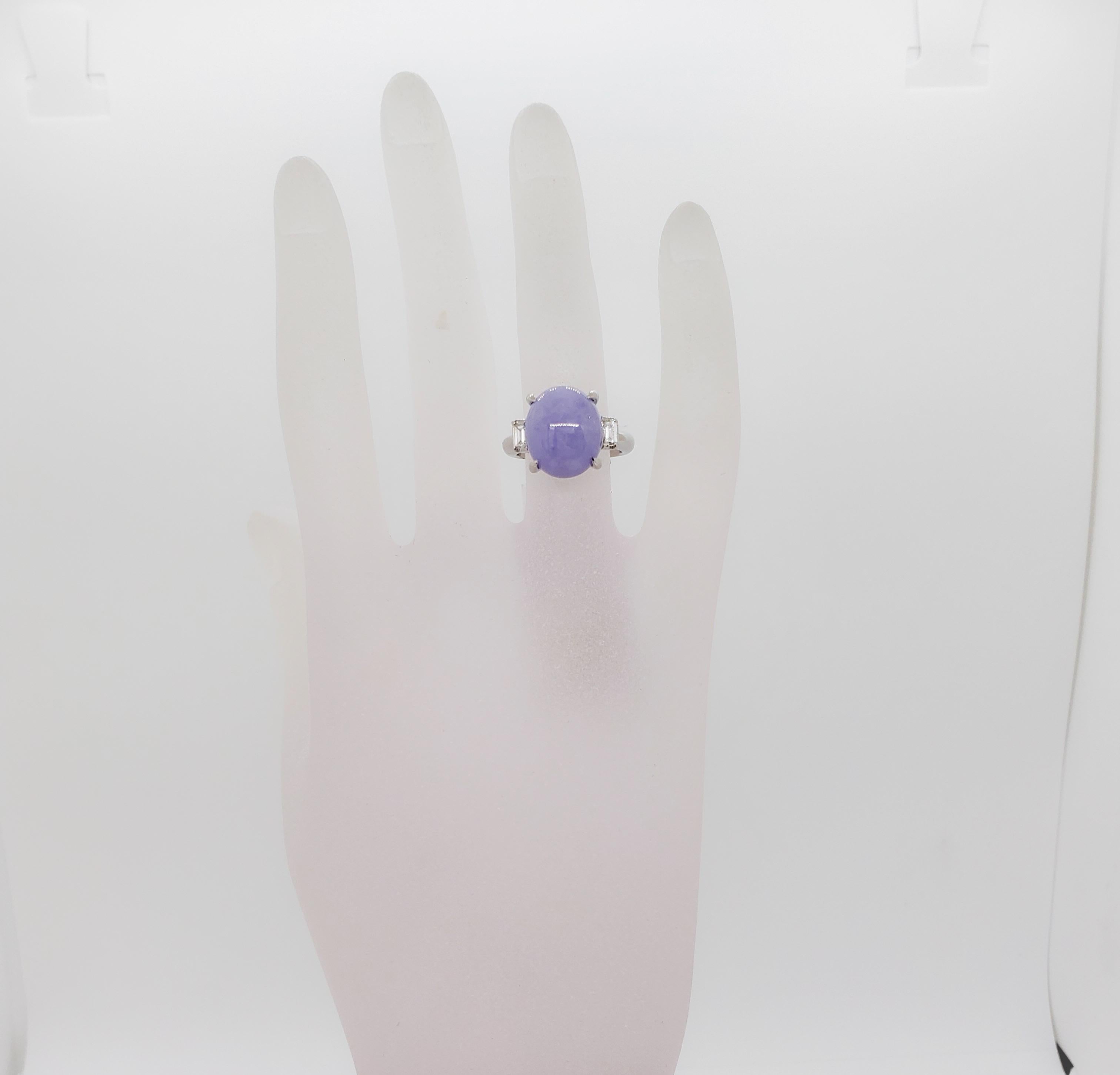 Stunning 9.21 ct. lavender jade oval cabochon with a beautiful light purple color.  On each end of the stone is an emerald cut diamond, good quality, white, and bright, weighing 0.19 ct. total.  Handmade platinum mounting in size 6.  This ring can
