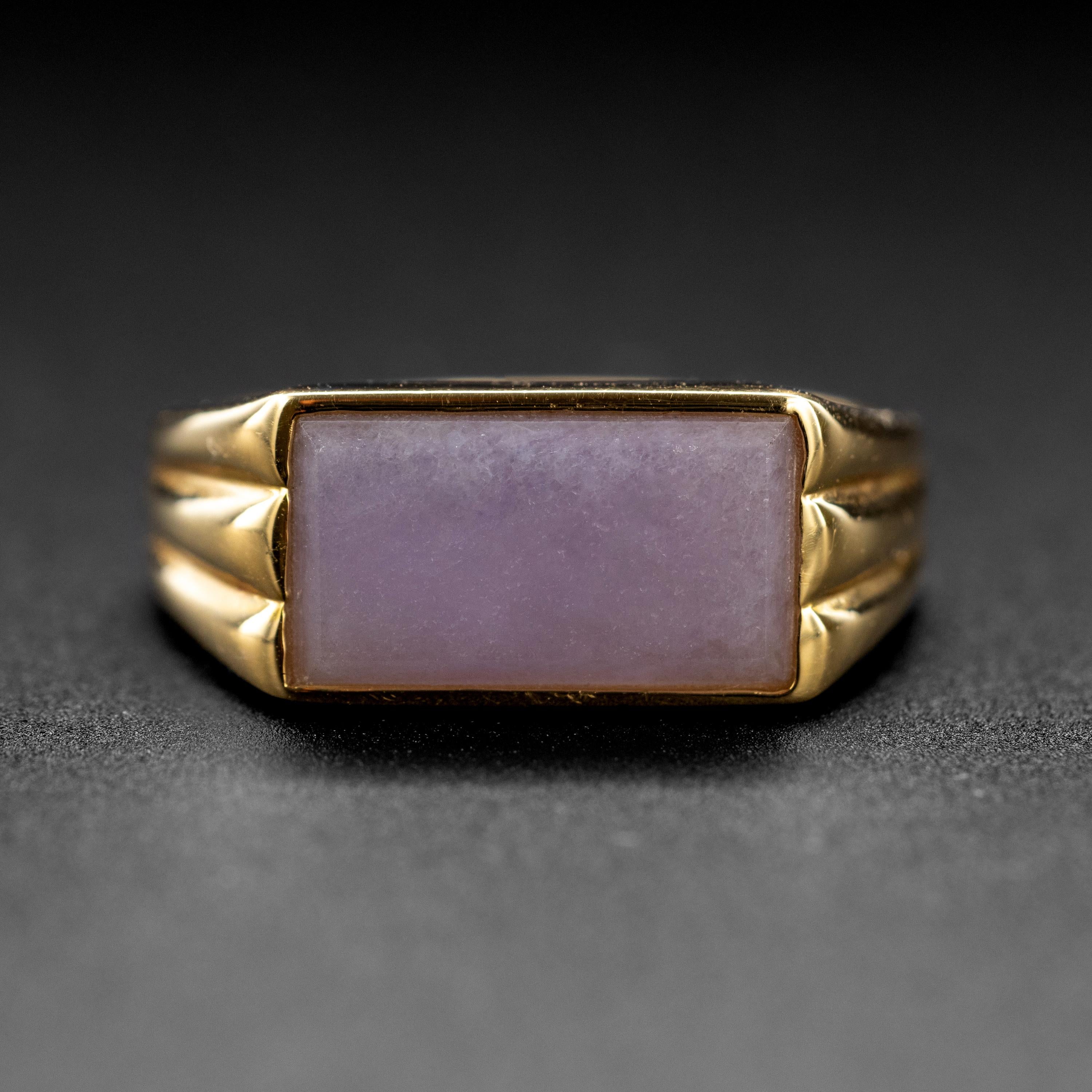 Featuring a 12mm x 6.7mm rectangular tablet of natural, untreated lavender jadeite jade, this sleek 14K yellow gold ring is a classic, understated ring for a man or a woman. Created in the 2000s but never worn, the ring is new. The ring weighs 5