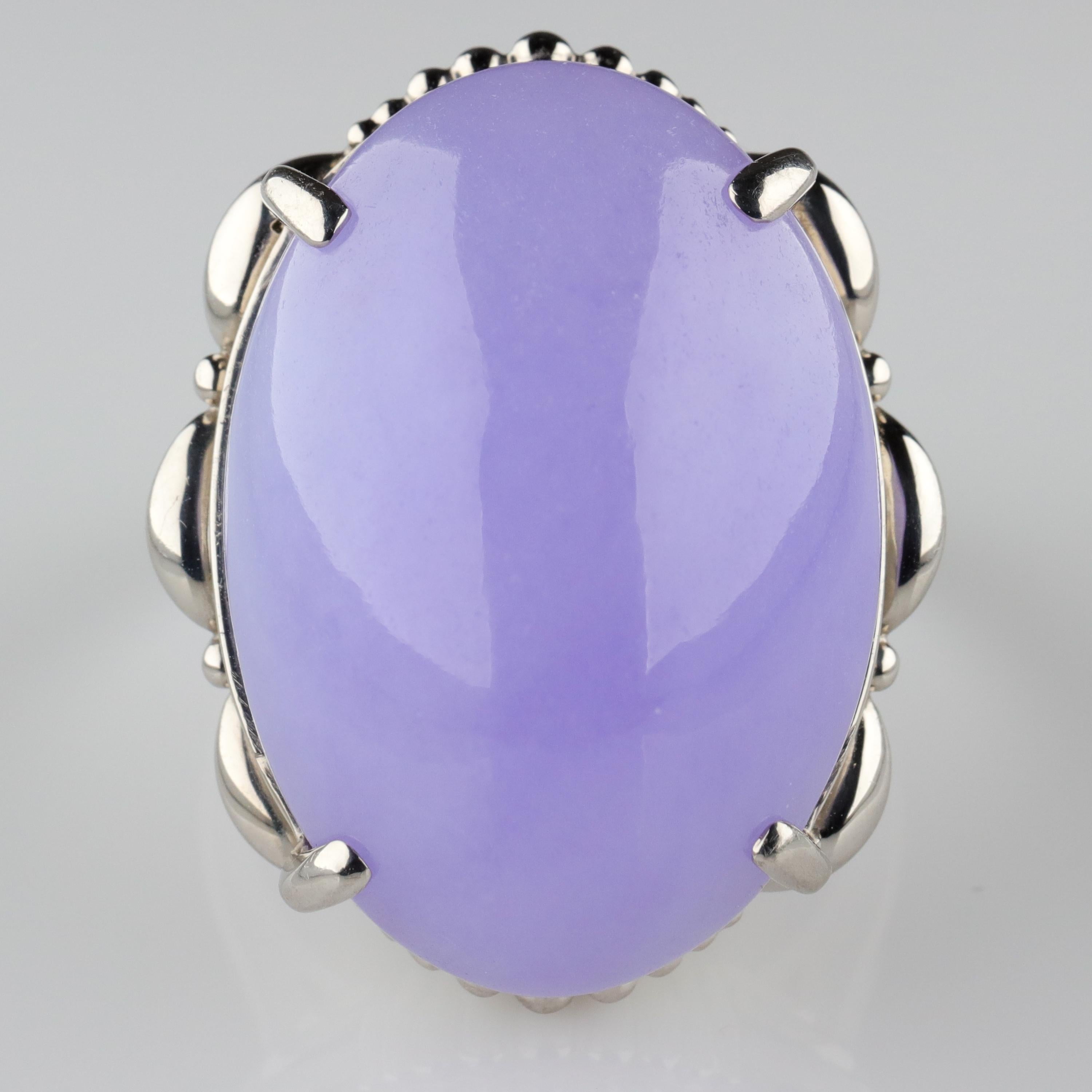 An enormous (26 mm x 18.62 mm x 10.30 mm) 42-carat lavender jadeite jade cabochon certified by Stone Group Labs to be 100% natural and untreated in any way is the thrilling centerpiece of this hand-fabricated heavy platinum ring. 

Even non-jewelry