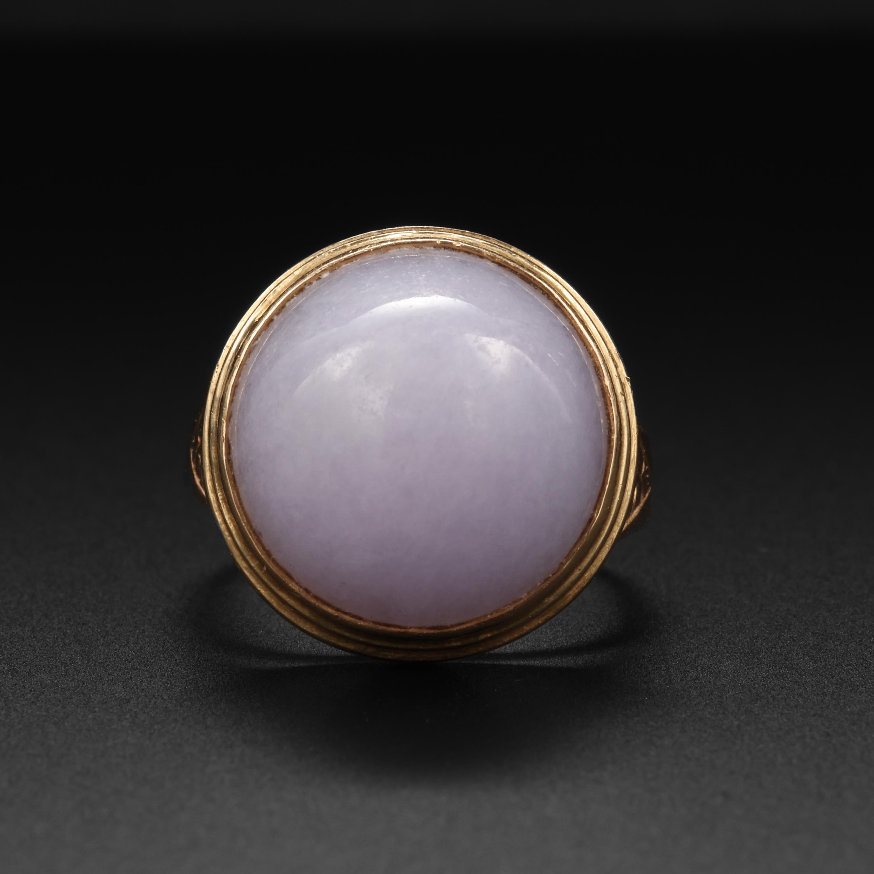 Created by the iconic Midcentury jeweler, Ming's of Hawaii, this entirely hand-fabricated ring in 14K yellow gold features a magnificent and luminous bright lavender oval bullet-shaped cabochon of natural and untreated Burmese jadeite. The jade