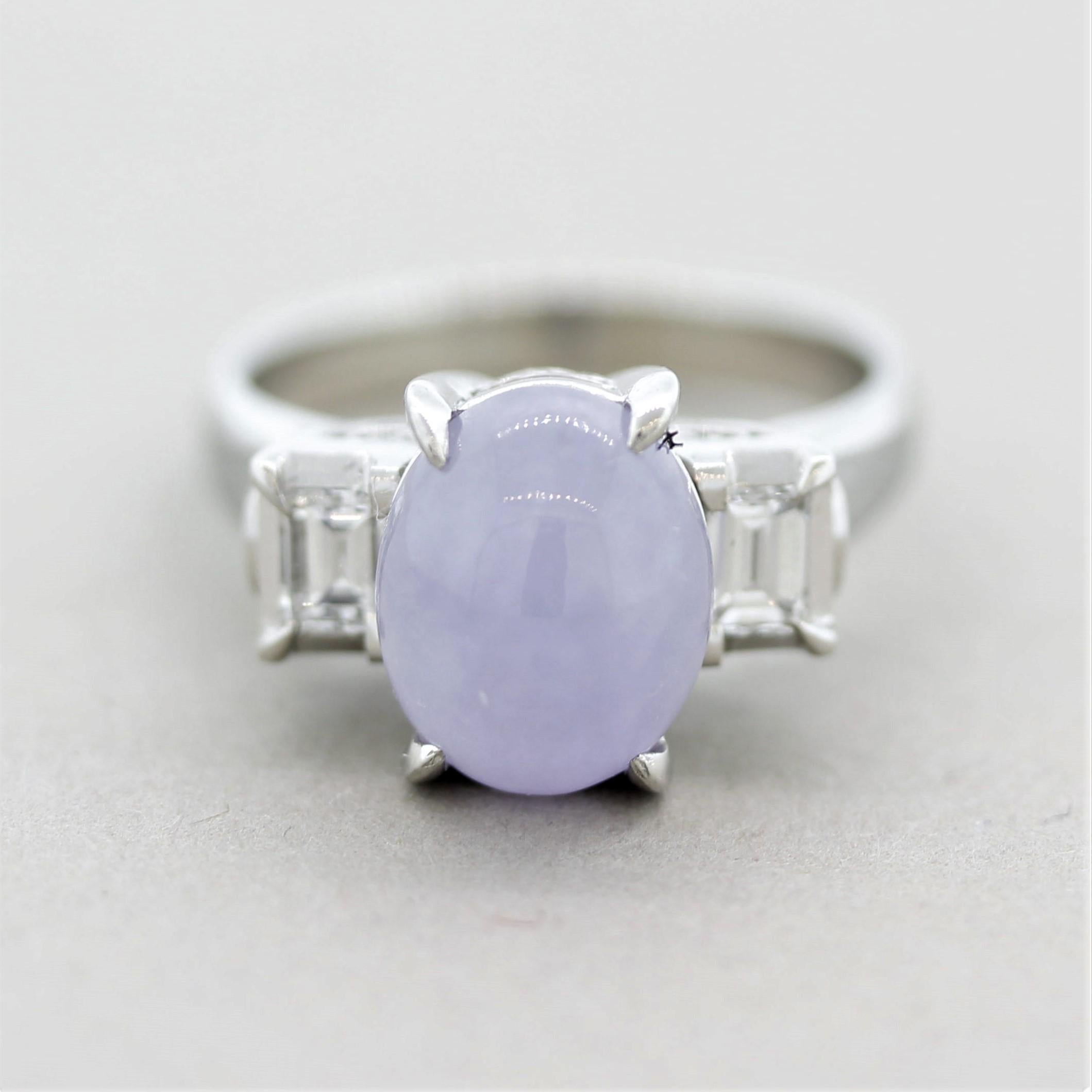 A classic 3-stone ring featuring a luscious lavender jade in the center. It weighs approximately 3 carats and has a soft glowing lavender color as light appears to emanate from the stone. It is accented by 2 baguette-cut diamonds set on its sides