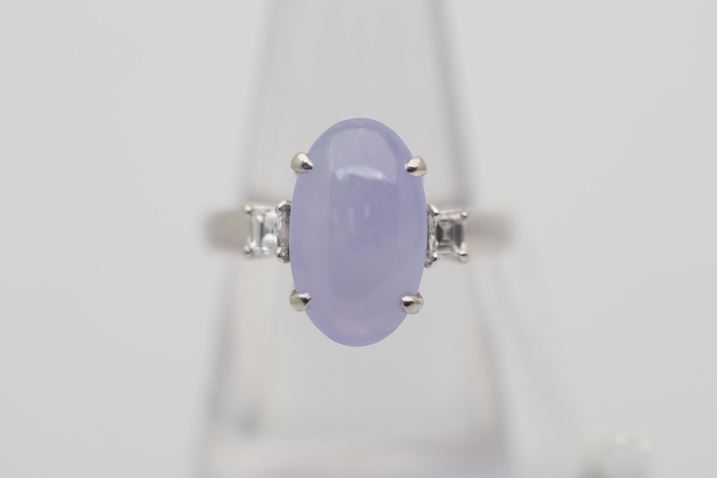 A sweet lavender color jade takes center stage of this platinum ring. It weighs 5.20 carats and has great translucency as it appears to glow as light hits the stone, an indicator of very fine quality. It is complemented by 2 square-shape diamonds